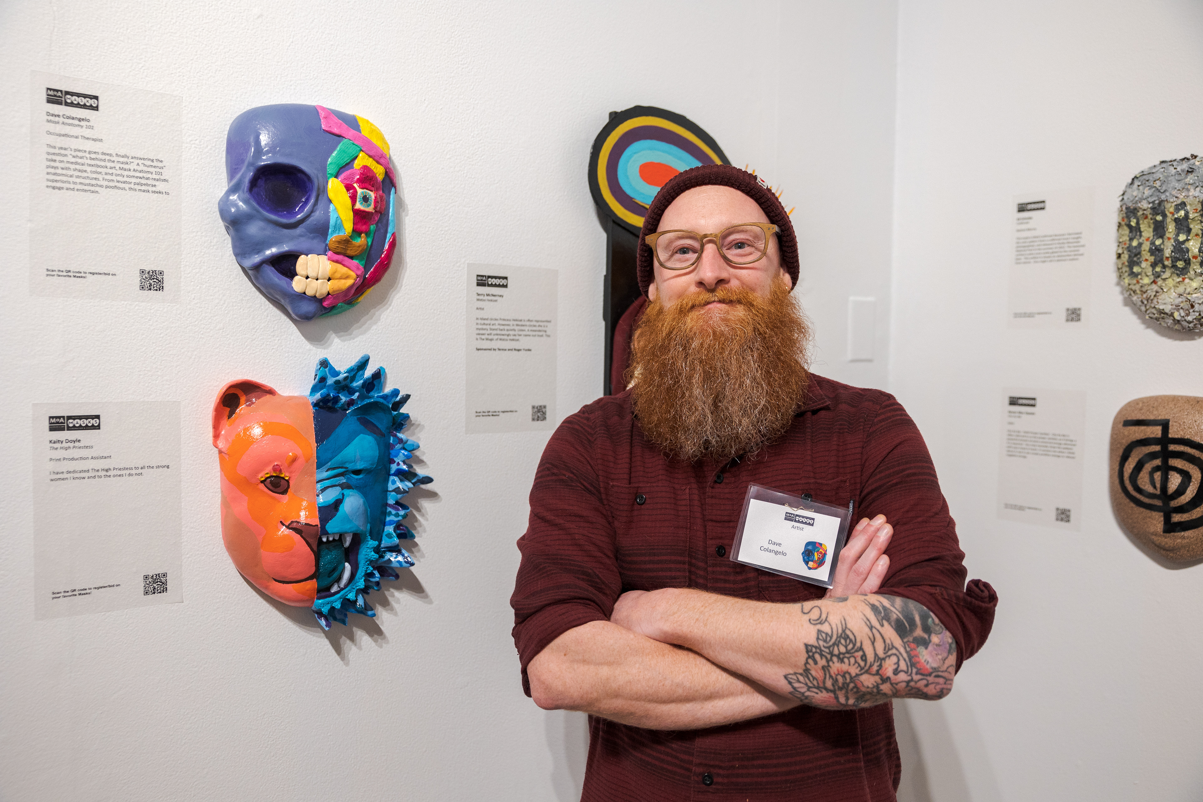 Dave Colangelo with his artwork, Mask Anatomy 101, during the opening night of the Masks Exhibition at the Museum of Art Fort Collins March 3. "I'm an occupational therapist, so in school I studied anatomy and physiology and had to learn all the ins and outs of the human body," Colangelo said. "I don't use any of that now, really, but I was always inspired by the art that these doctors and these artists put into these textbooks, so I did kind of a humorous take on what a face would look like. Fake muscles - with a little bit of real muscles - and silly colors." Colangelo has been a contributor to the exhibit for six years and spent two months on this year's mask.
