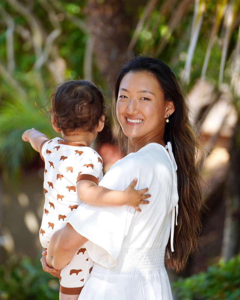 Young mother smiling while holding baby boy