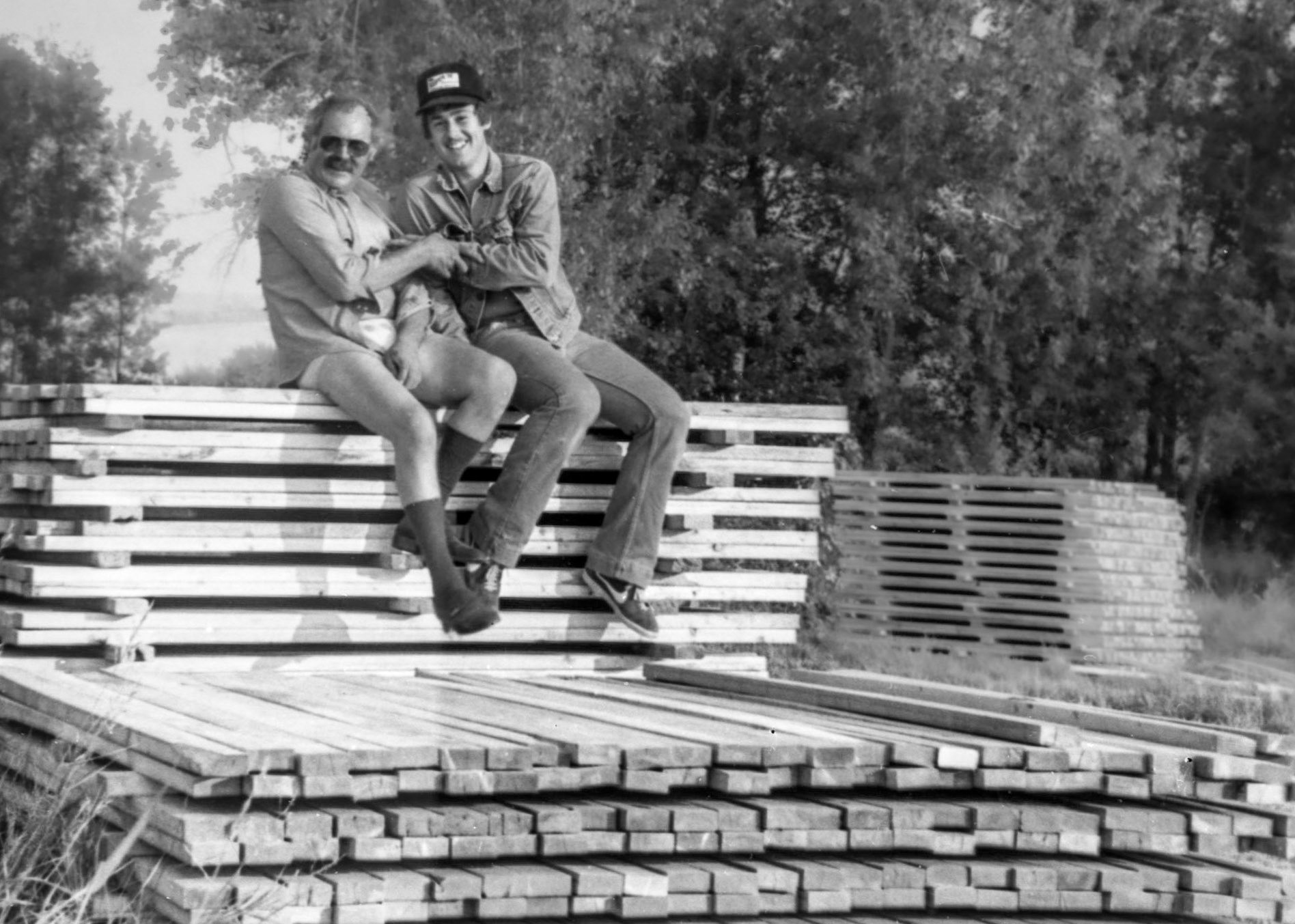 Circa 1979~80: John Huculak and son Brian stacking lumber at Huculak family farm northeast of WIllingdon, AB. Photo credit: Mike Kachuk.