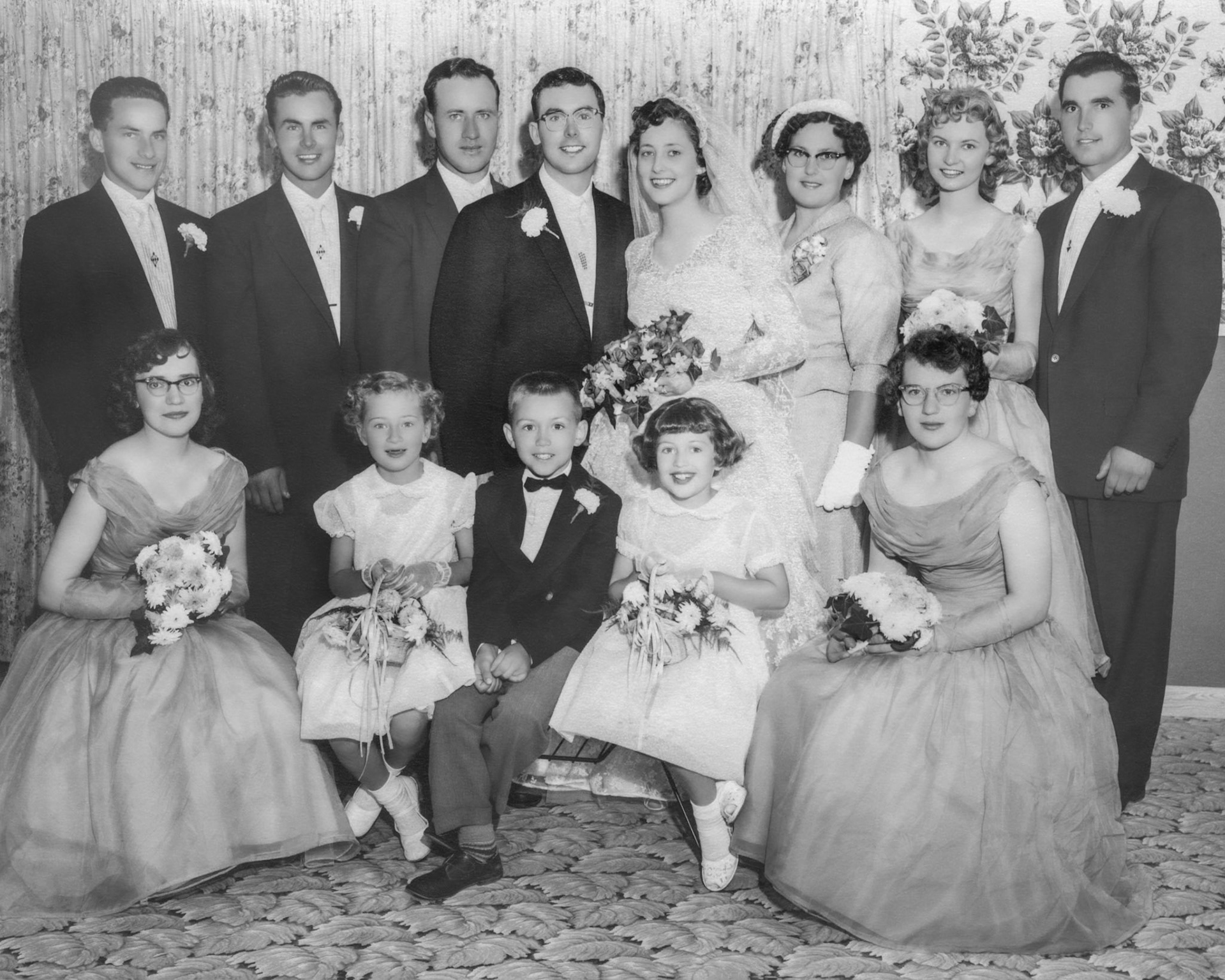 Wedding Party 16 June 1956 • Back L to R: likely Andy Garrick or possibly Norman Kereluk - George Huculak (grooms brother) - George Kachuk (best man) - Johnny Huculak and Kathleen [Shewchuk] Huculak - Lena [Shewchuk] Tatarin (brides sister) - Pat Proniuk - Nick Tatarin. Seated L to R: Julia Kocak - Robben Shewchuk - Donald Romanko - Julia Megley - Evelyn Shewchuk. Grooms man missing either likely Andy Garrick