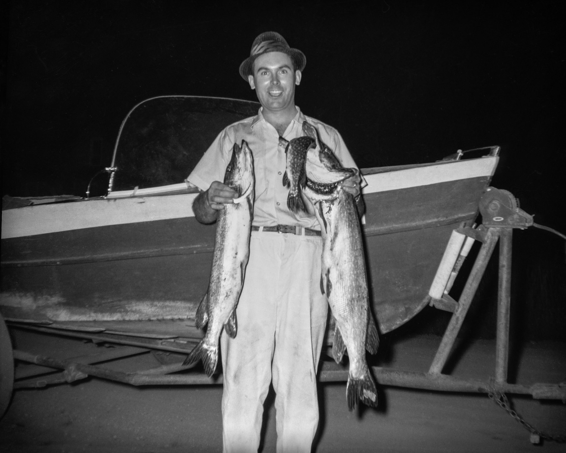 1961 • John Huculak (28) showing the boys how to land the big ones. Bonnie Beach, Alberta