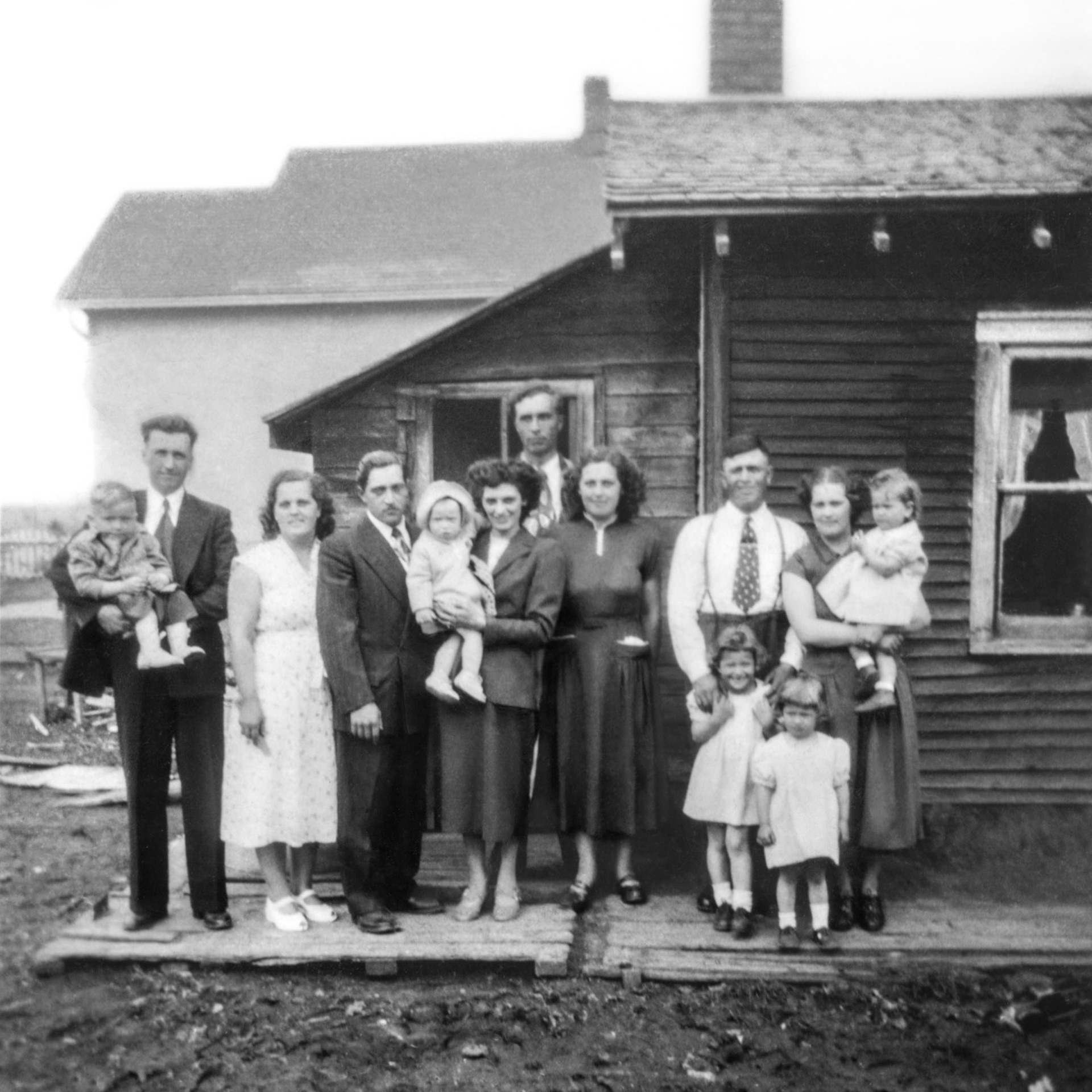 1951 • Romanko - Shewchuk - Tatarin - Megley families. L to R: Metro Romanko (30) holding son Donald (3) - Eleanor [Shewchuk] Romanko (27) - Steve Shewchuk (26) - Sadie [Semeniuk] Shewchuk (27) holding daughter Robben (1) - Lena [Shewchuk] Tatarin (22) - John Tatarin (25) behind Lena - Metro Megley - Nettie [Shewchuk] Megley (29) holding daughter Pat (2) - daughters standing Lorna (6) - Julia (4).