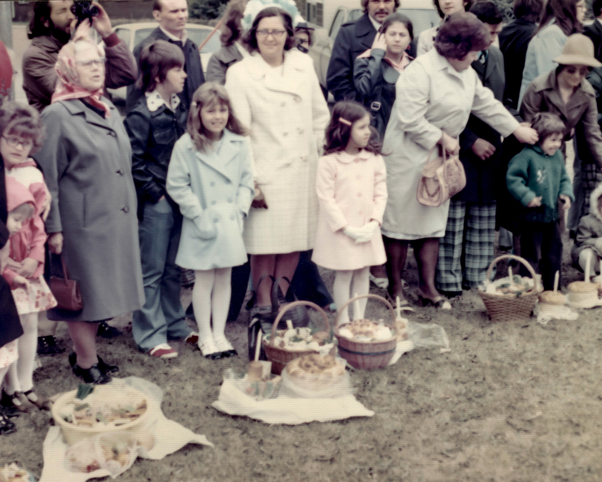 1975 • Christina [Huculak] Shewchuk image left in the gray coat. Brian Huculak (black jacket, red sneakers), Lee-Ann Huculak (blue coat), Kathleen [Shewchuk] Huculak (hat), Sherri Huculak (pink coat). Olli Megley behind Sherri. Don Stefaniuk next to male holding camera. Ukrainian Easter, Willingdon, AB. Photo Credit: Unknown, possibly John Huculak.
