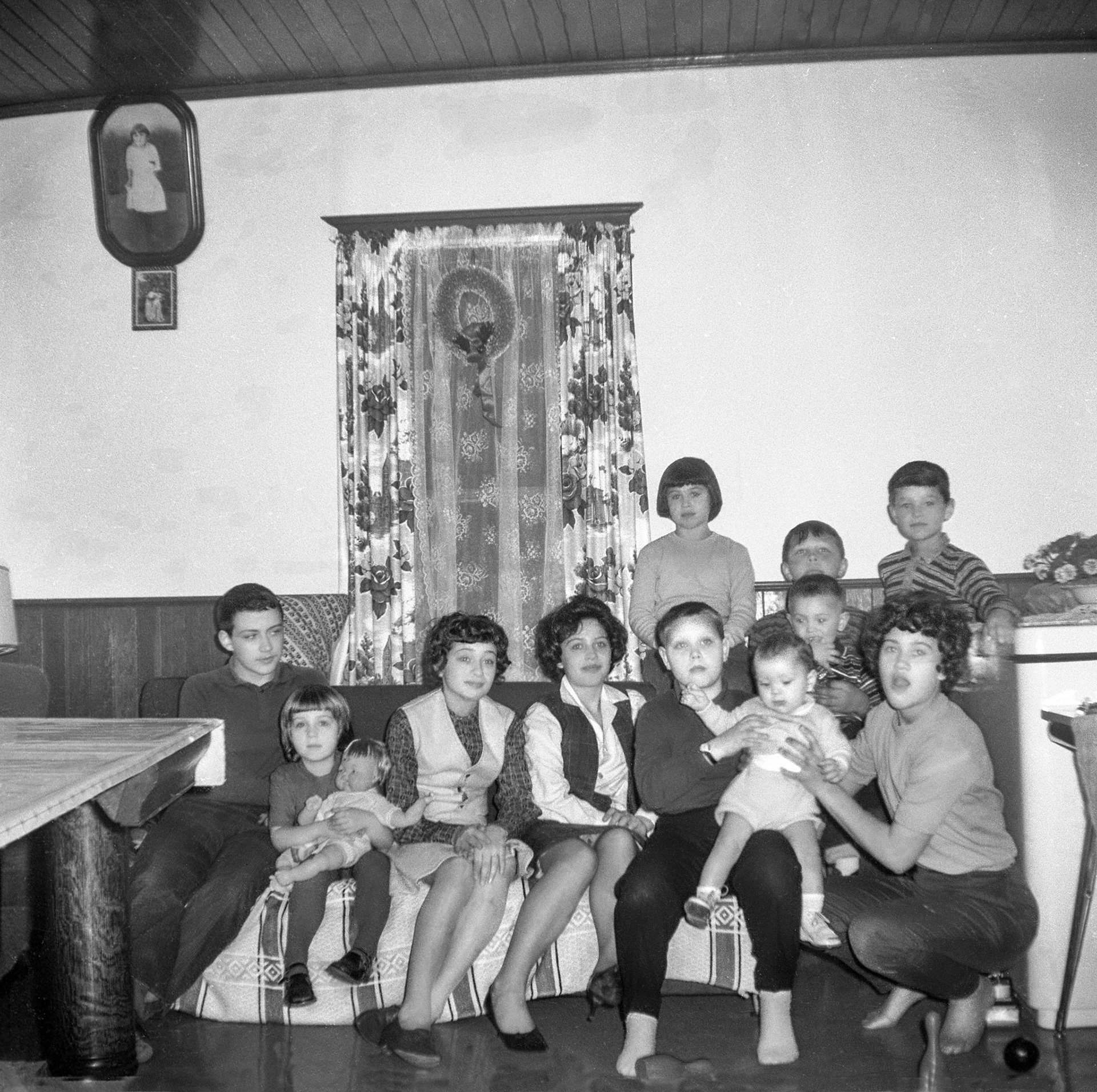 Circa 1962~63: taken at Mike M Shewchuk farm house: L to R:  Donald Romanko, Chris Romanko (holding doll), Robben Shewchuk, Julie Megley, Barry Romanko (infant on lap), Infant being held David Romanko, Pat Megley holding infant. Seated behind is Olie Megley near window, Gerry Tatarin holding Jimmy Megley, Carl Tatarin.