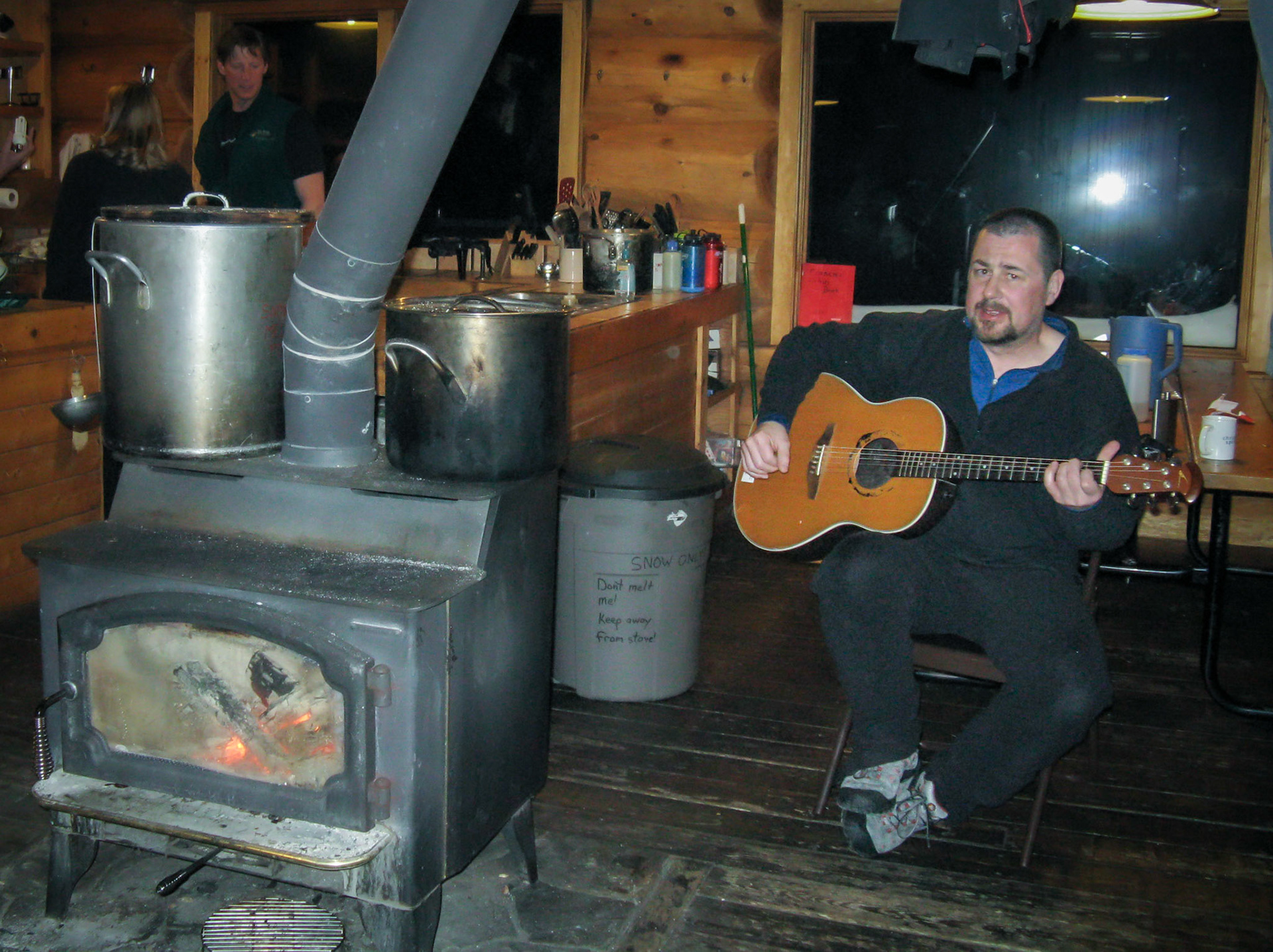 02 April 2009: Brian Huculak pick'n and grin'n at Frances Alpine Hut, near Breckenridge, Colorado. Photo credit: Paula Rosson .