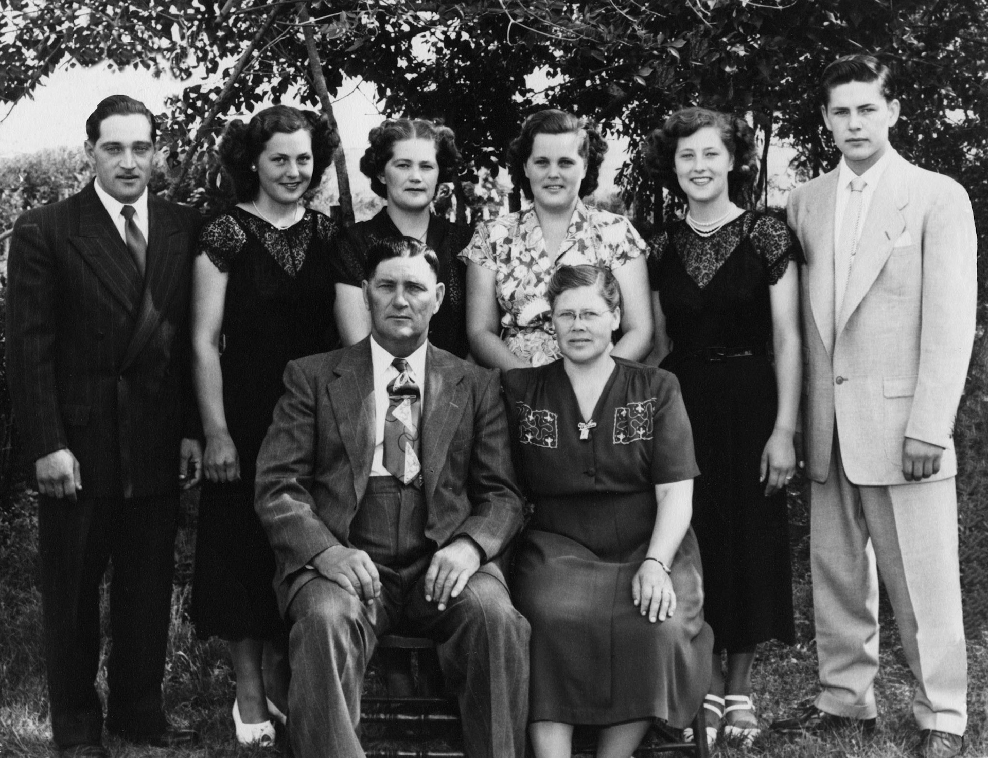 Circa 1950 • Seated Mechalio (Mike) Shewchuk (52) &amp; Christina [Huculak] Shewchuk (47). Children standing L to R: Steve (27) -  Lena (23) - Nettie (30) - Eleanor (28) -  Kathleen (18) - Paul (19). Taken on the family farm near Willingdon, AB.