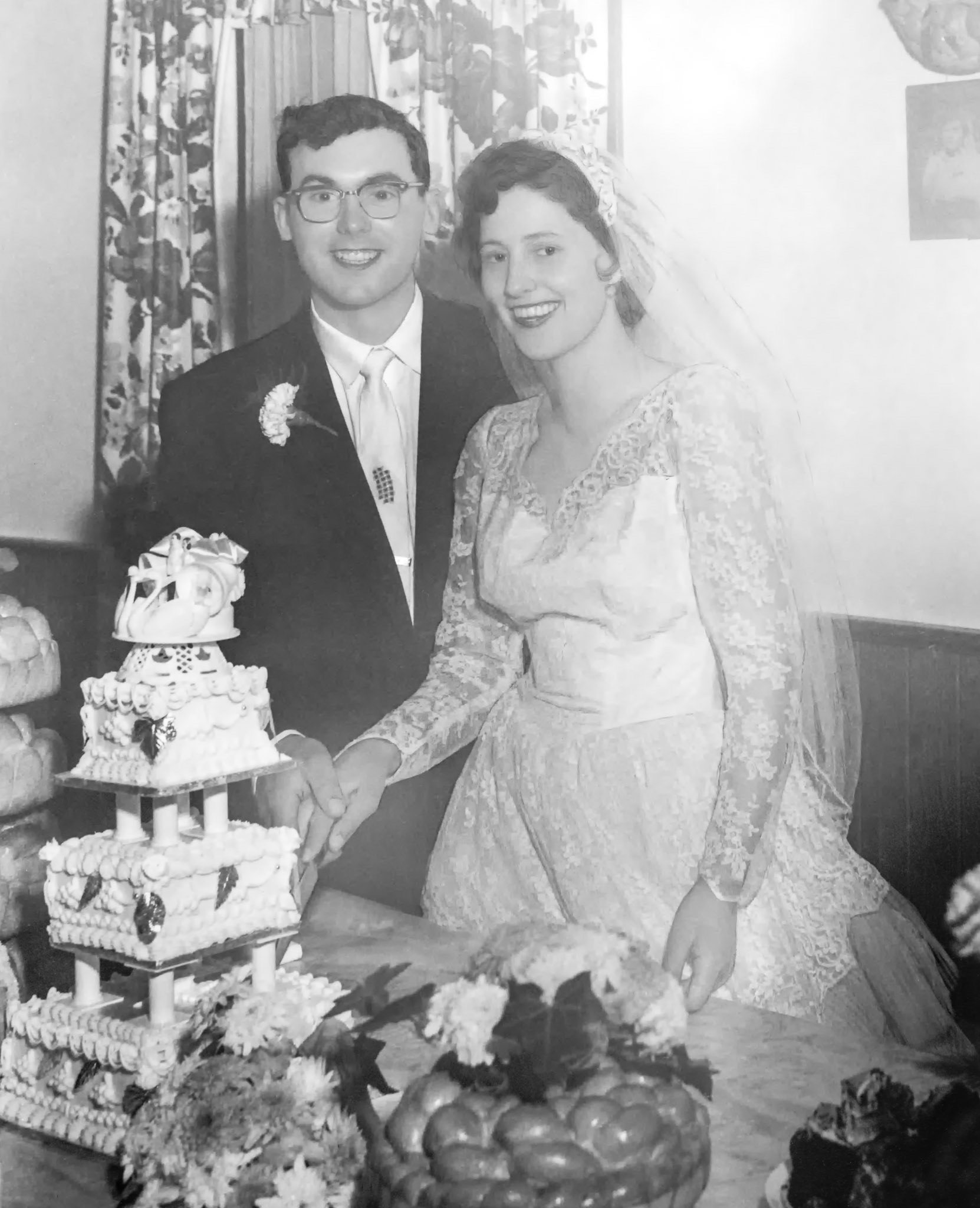 John Huculak, Kathleen [Shewchuk] Huculak cutting the wedding cake at the family farm home of Kathleen's parents Mike and Christina Shewchuk near Willingdon, AB.