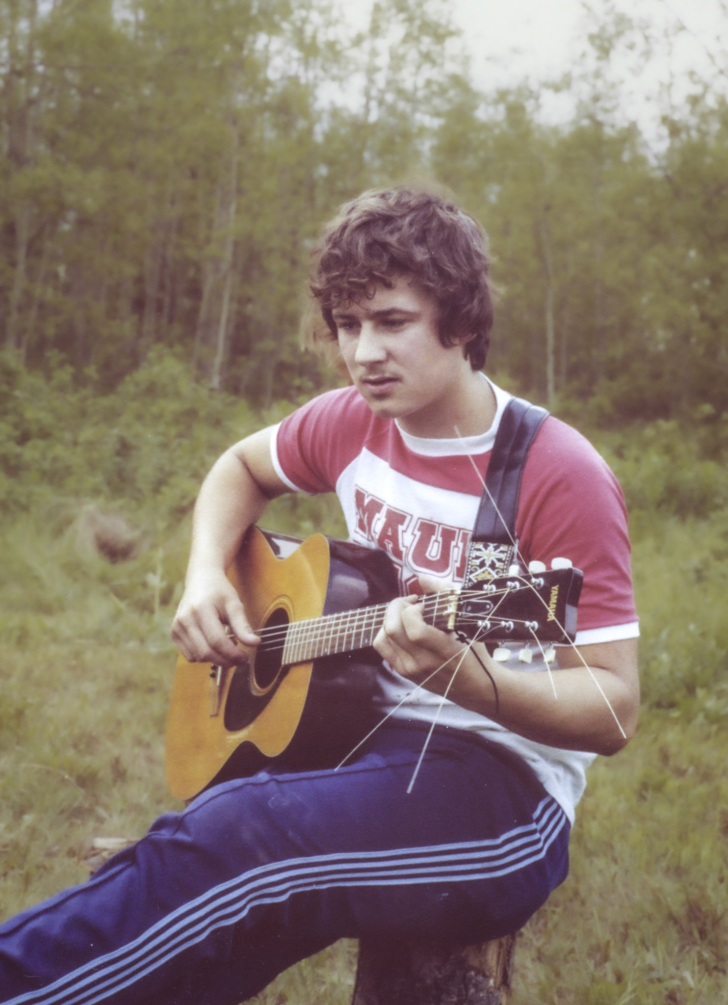 Circa 1979: Brian Huculak playing a tune on the Richard Toogood farm near Edmonton, Alberta.