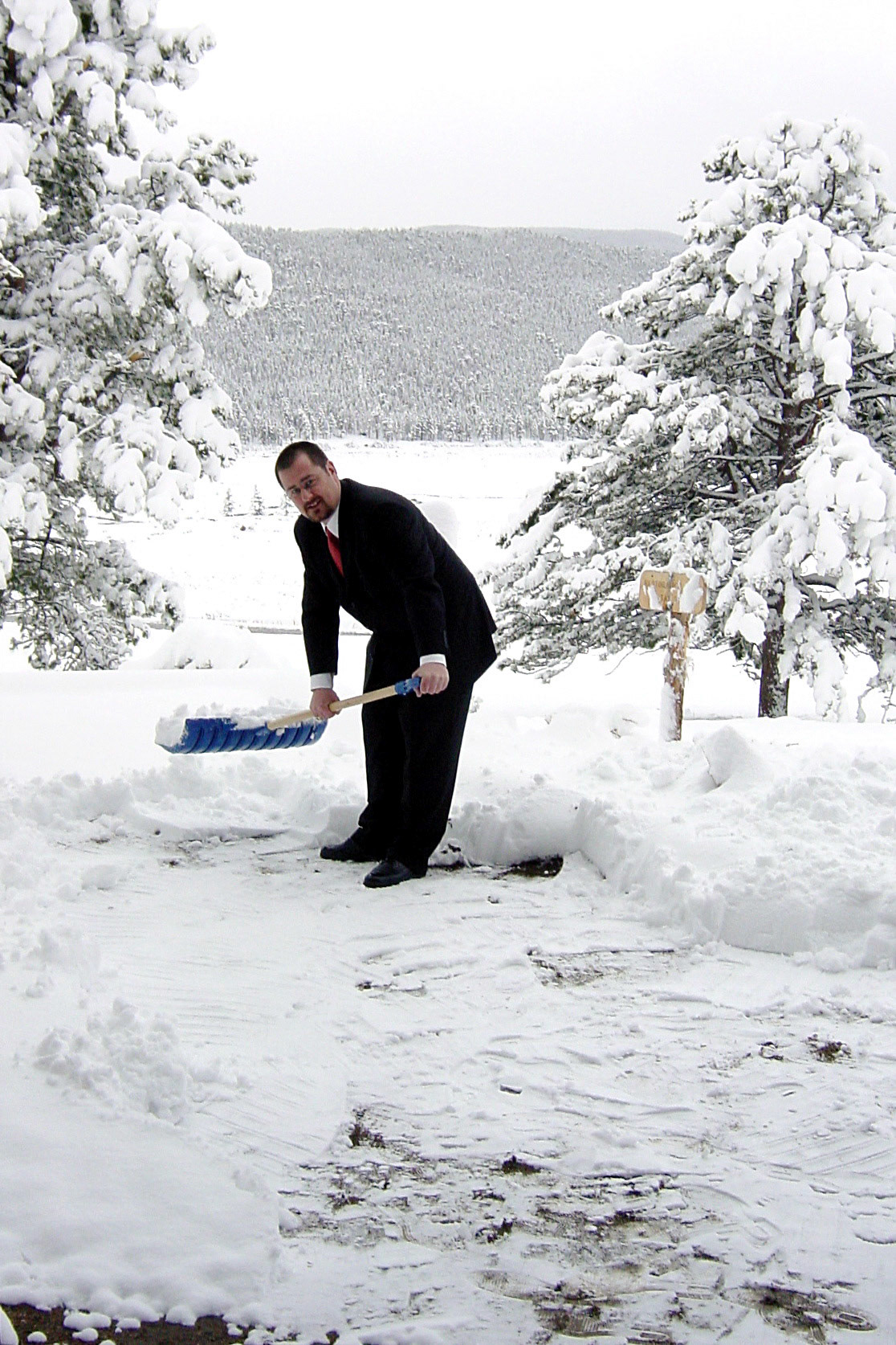 10 May 2003: The groom - Brian Huculak - digging out a spot for the service after the 10~12 inch snow storm in Rocky Mountain National Park, Colorado. Photo credit: David Maze (best man).