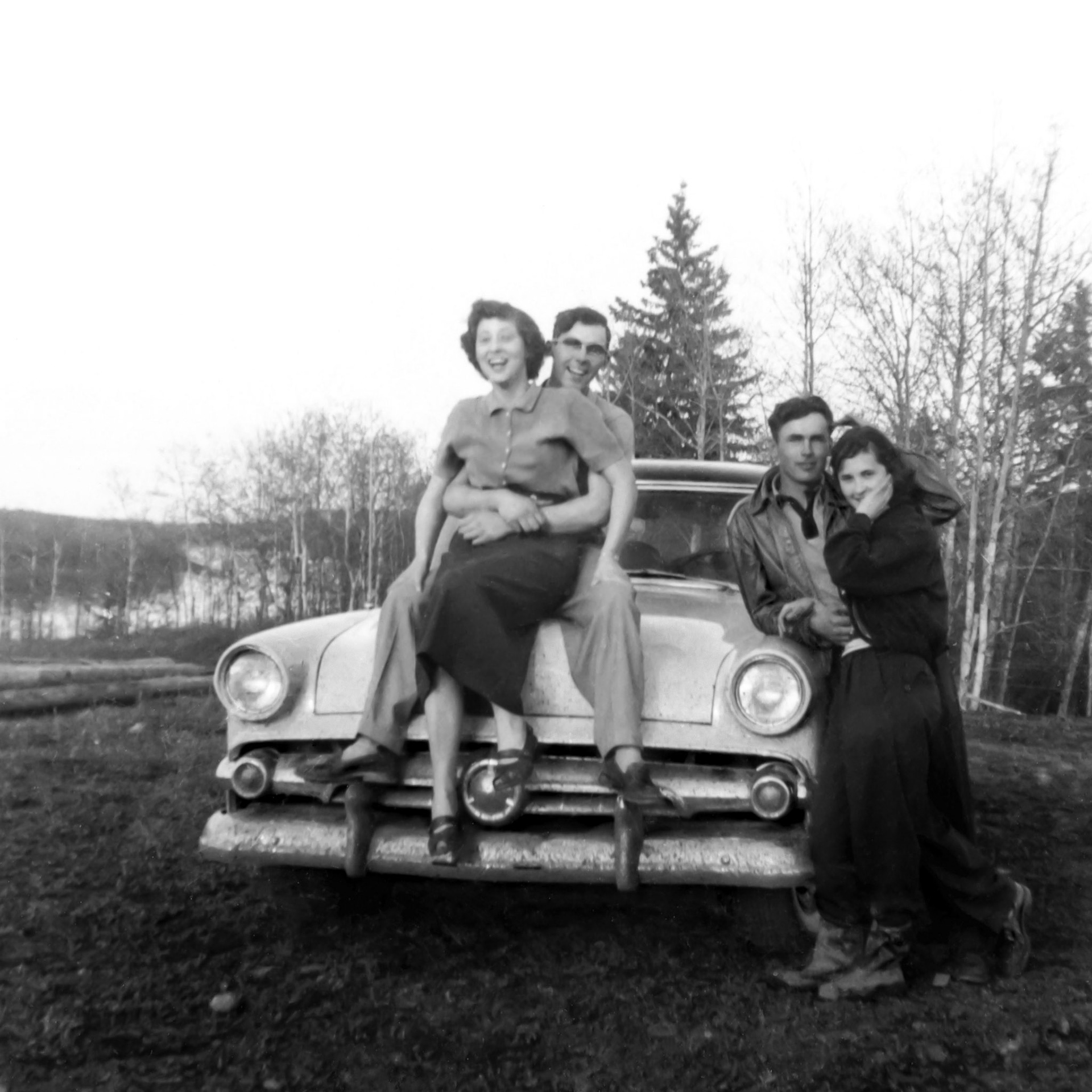 Circa 1953 • Brothers John (20) and George (Willis) Huculak (21) - Kathleen Shewchuk (19) seated on car - standing unknown famale. North shore of North Saskatchewan River after taking Desjarlais Ferry.