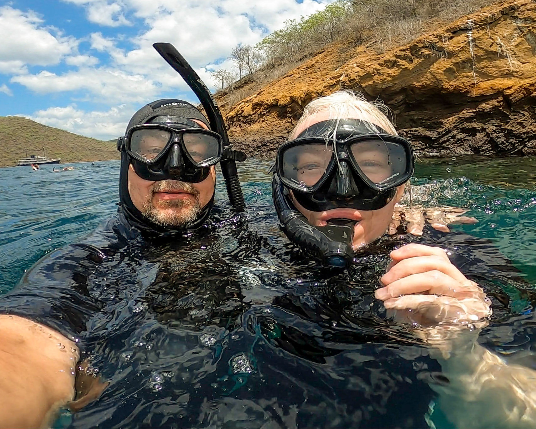 09 Juy 2019: Brian Huculak (L) and Paula Rosson (R) getting wet in the Galápagos Islands. Photo credit:Brian Huculak (selfie)