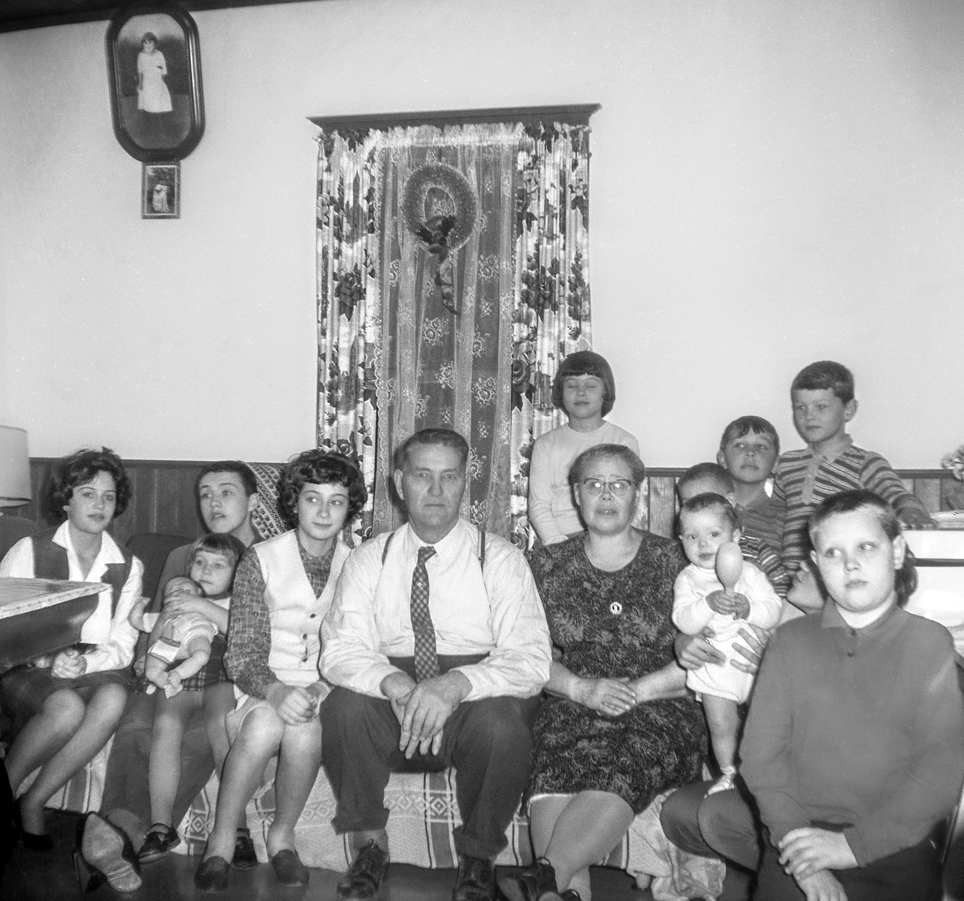 Christmas 1962 • Mike Shewchuk and Christina [Huculak] Shewchuk center with grandchildren. Photo taken at their farm near Willingdon, AB. Grandchildren L to R: Julia Elaschuk - Donald Romanko - Christine Romanko (in his lap) - Robben Shewchuk - Olli  Megley - David Romanko (infant) - Gerald Tatarin (behind) - Carl Tatarin (back right) - Barry Romanko (right).