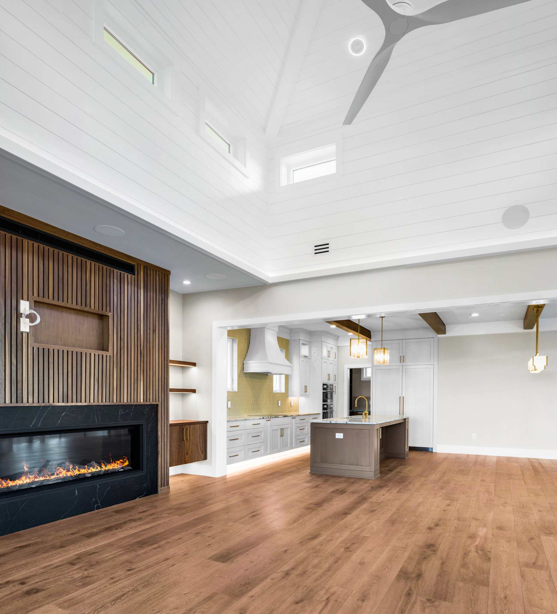Spacious open floor plan with engineered hardwood flooring, designer lighting, and a custom entertainment feature wall built for upscale North Carolina living.