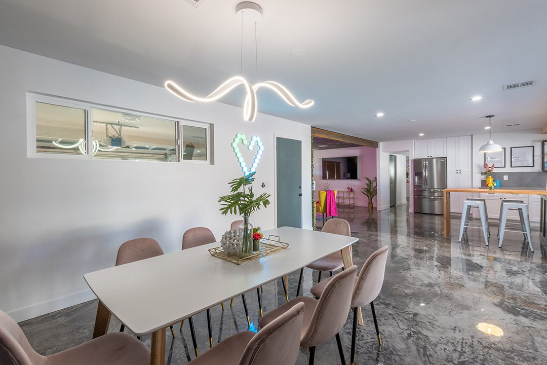 Dining room with neon light fixture
