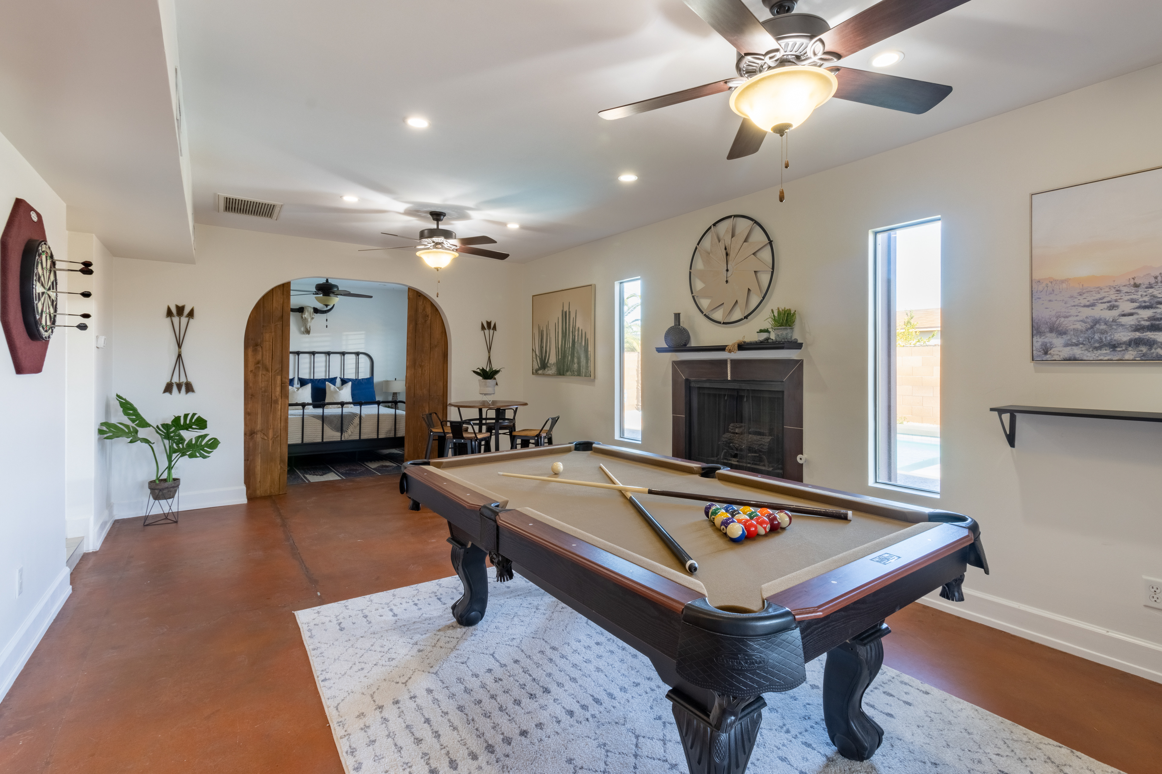 Game room with pool table and arched doorway