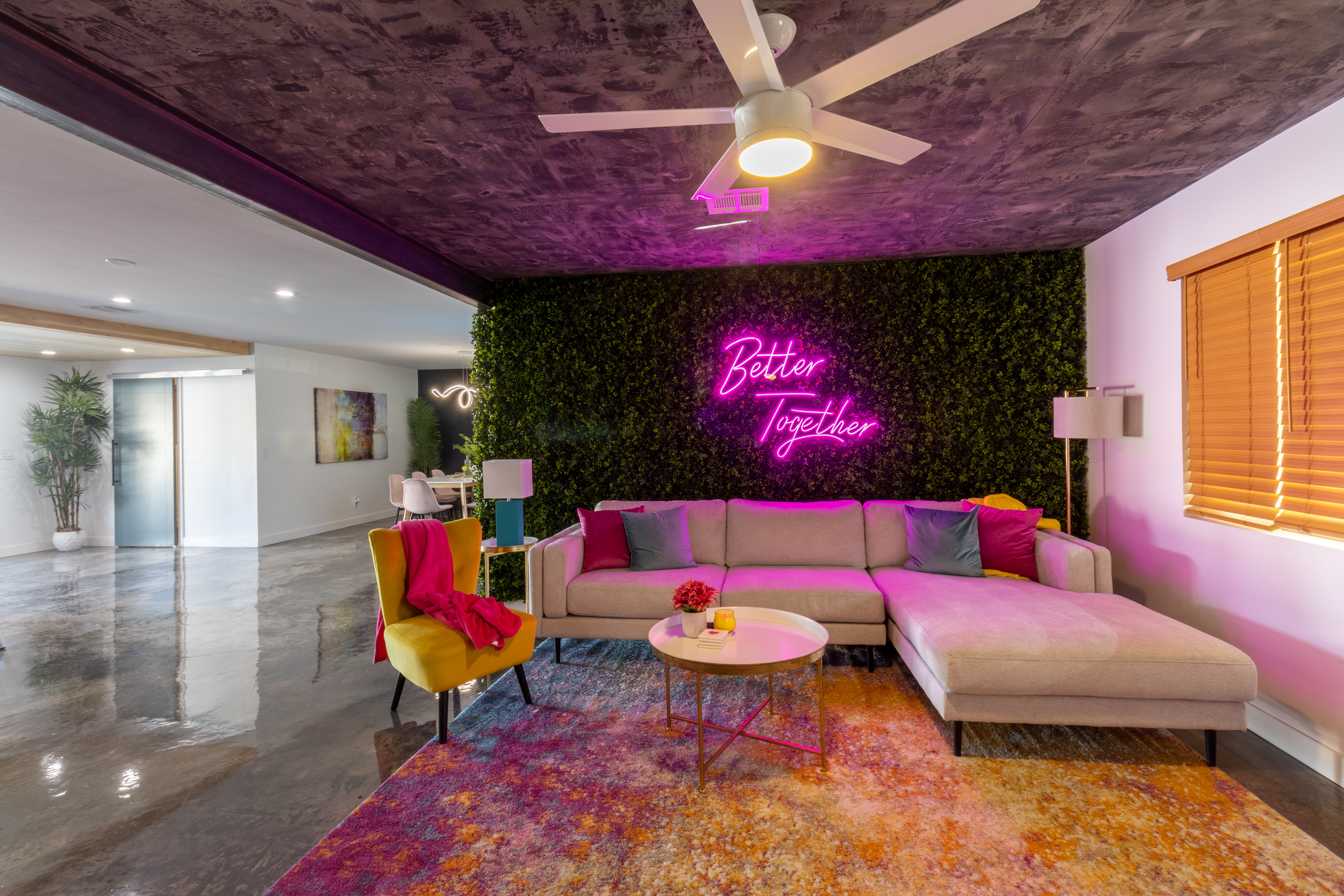Living room with neon sign and living green wall