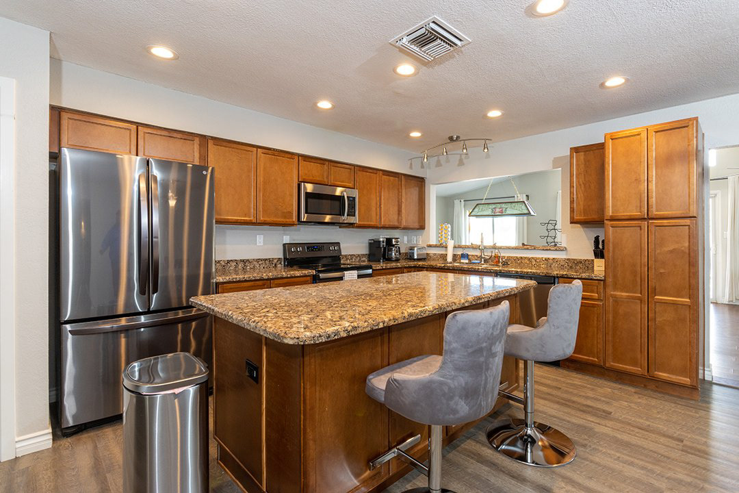 Kitchen with stainless appliances and granite island