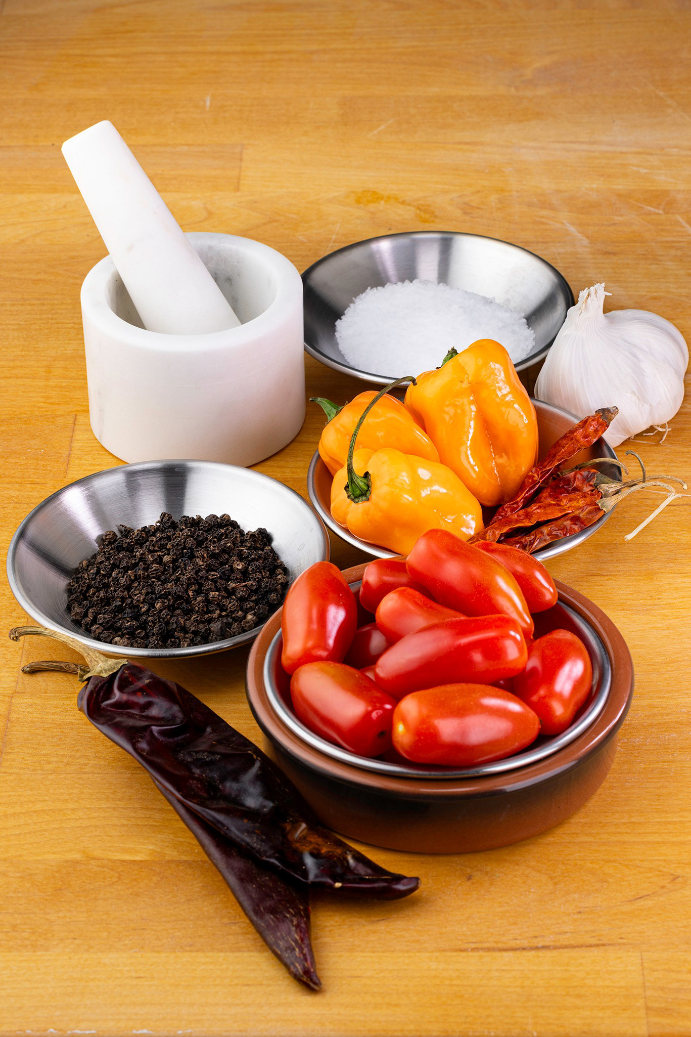 Spices, mortar and pestle, tomatoes and black pepper, food photography