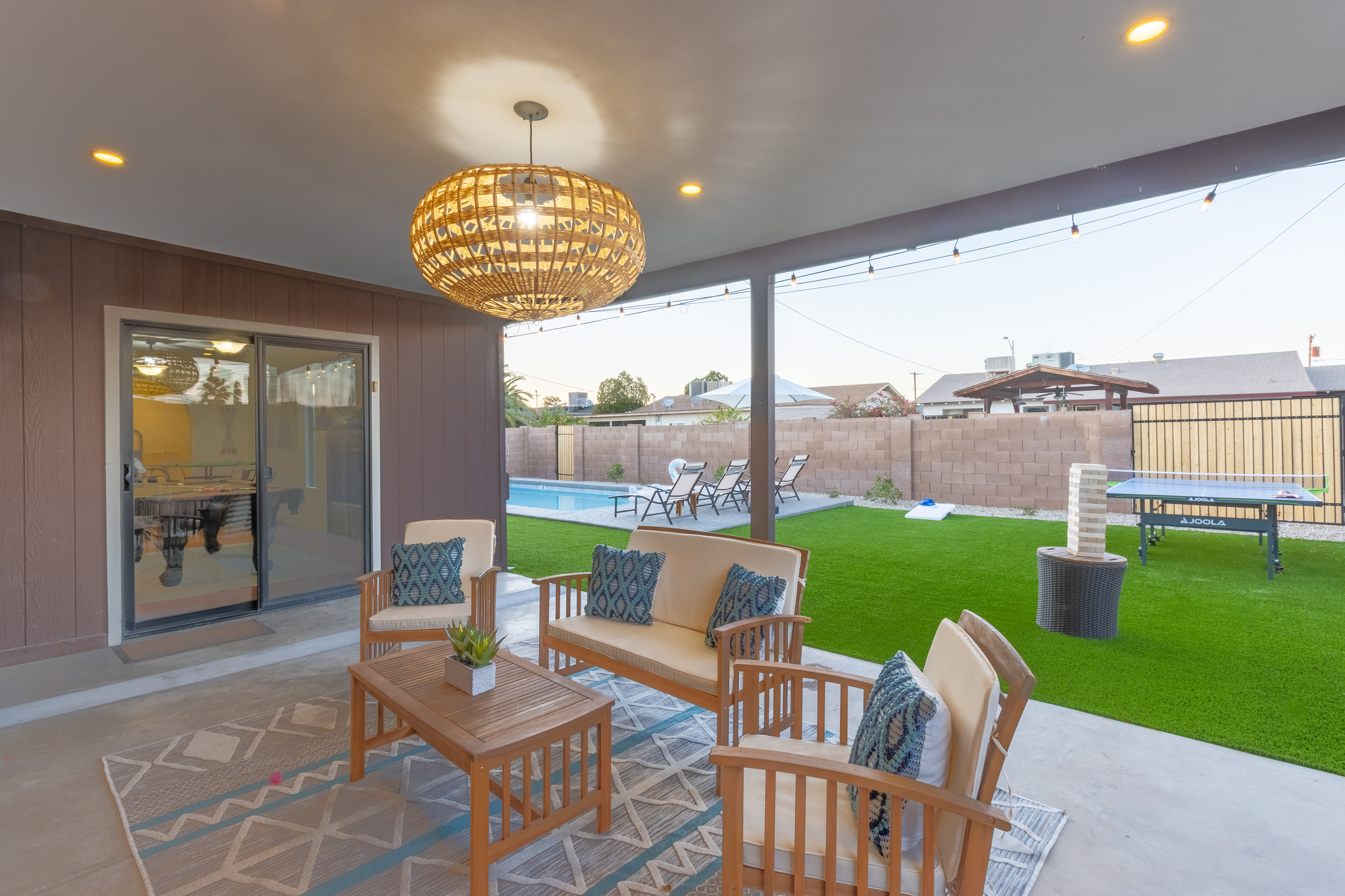 Covered patio seating with rattan pendant
