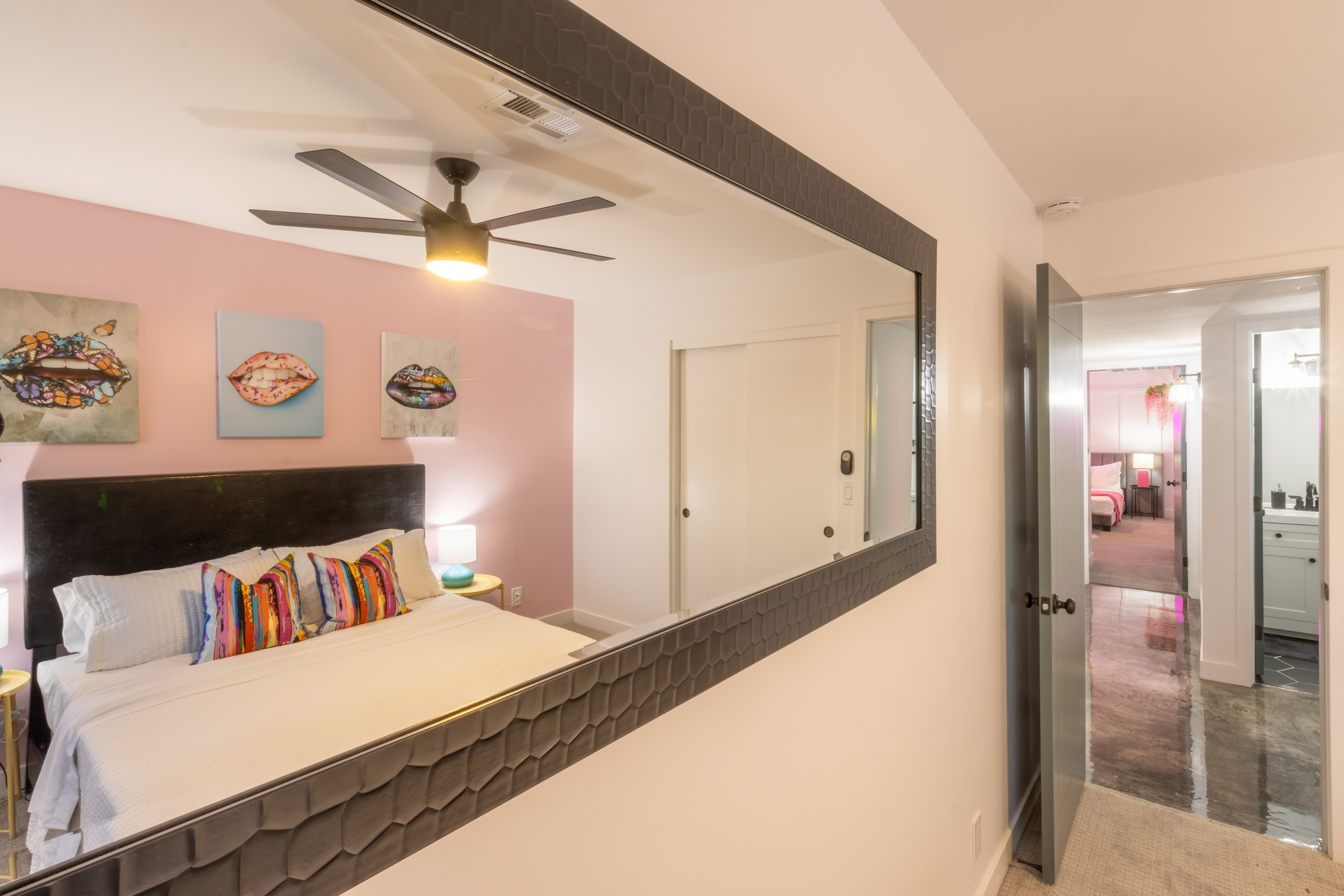 Bedroom reflected in a large floor mirror
