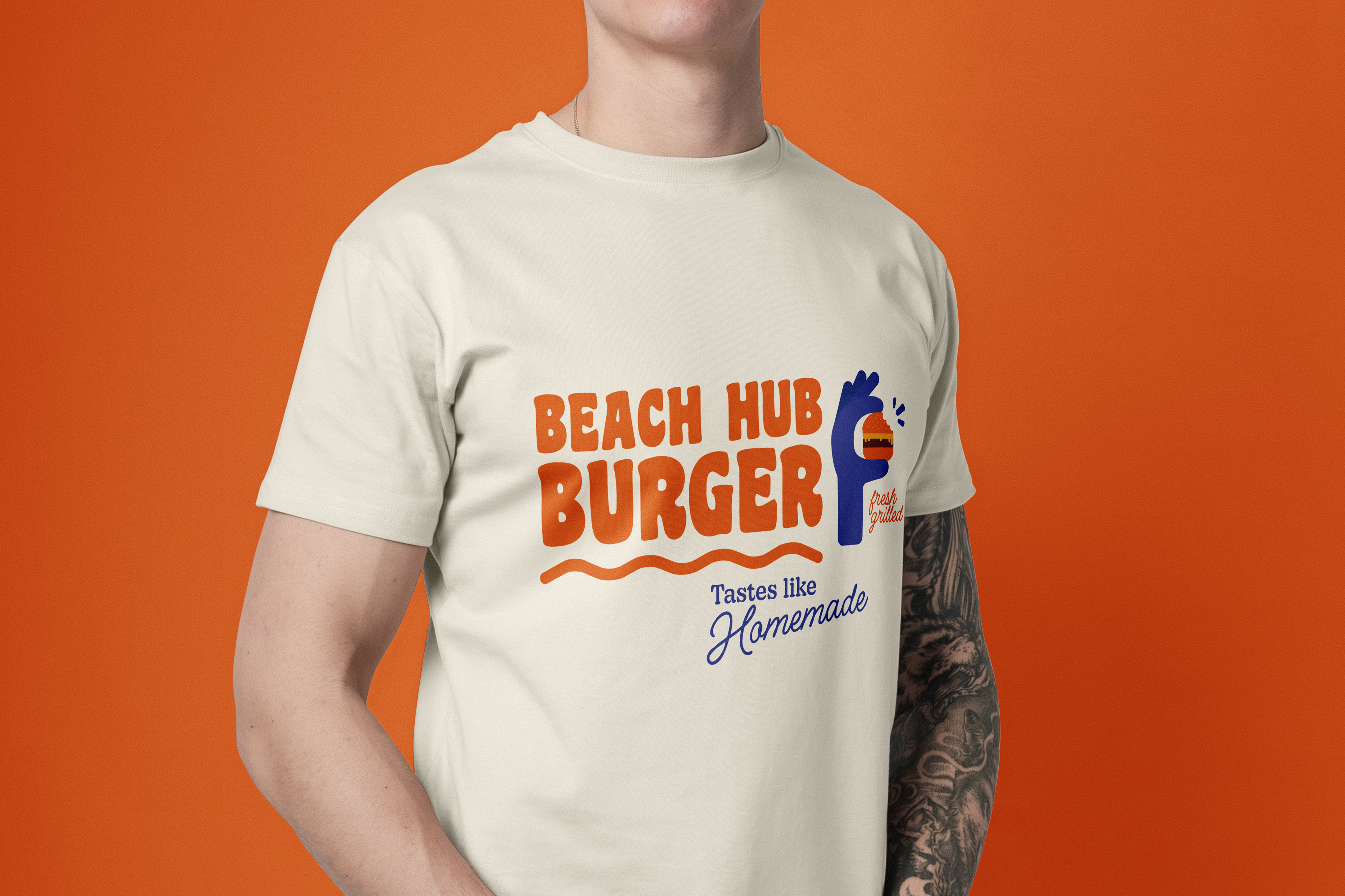 Man wearing a off-white T-Shirt with the Beach Hub Burger Logo