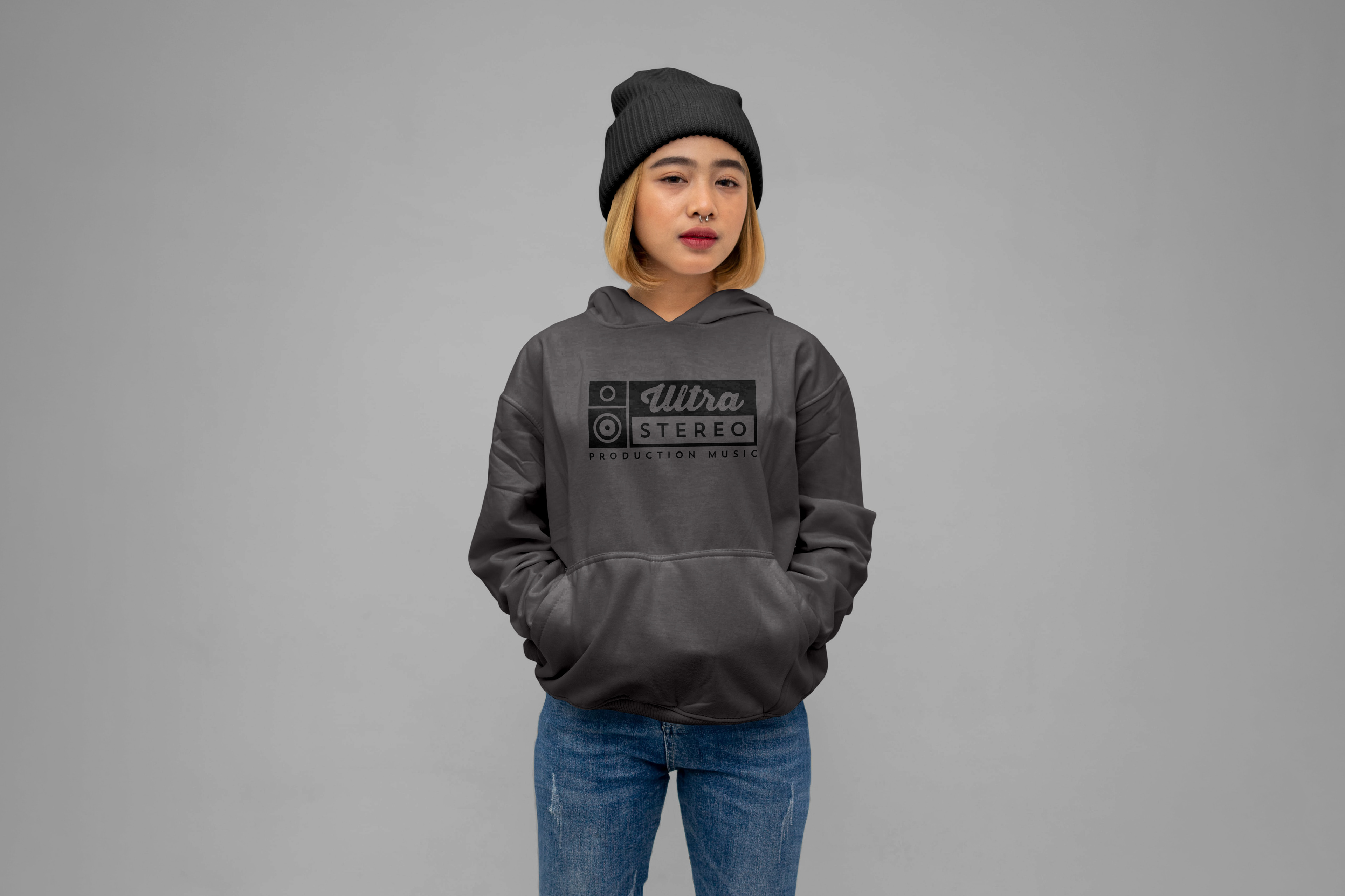 Girl wearing a grey hoodie with Ultrastereo logo on the front