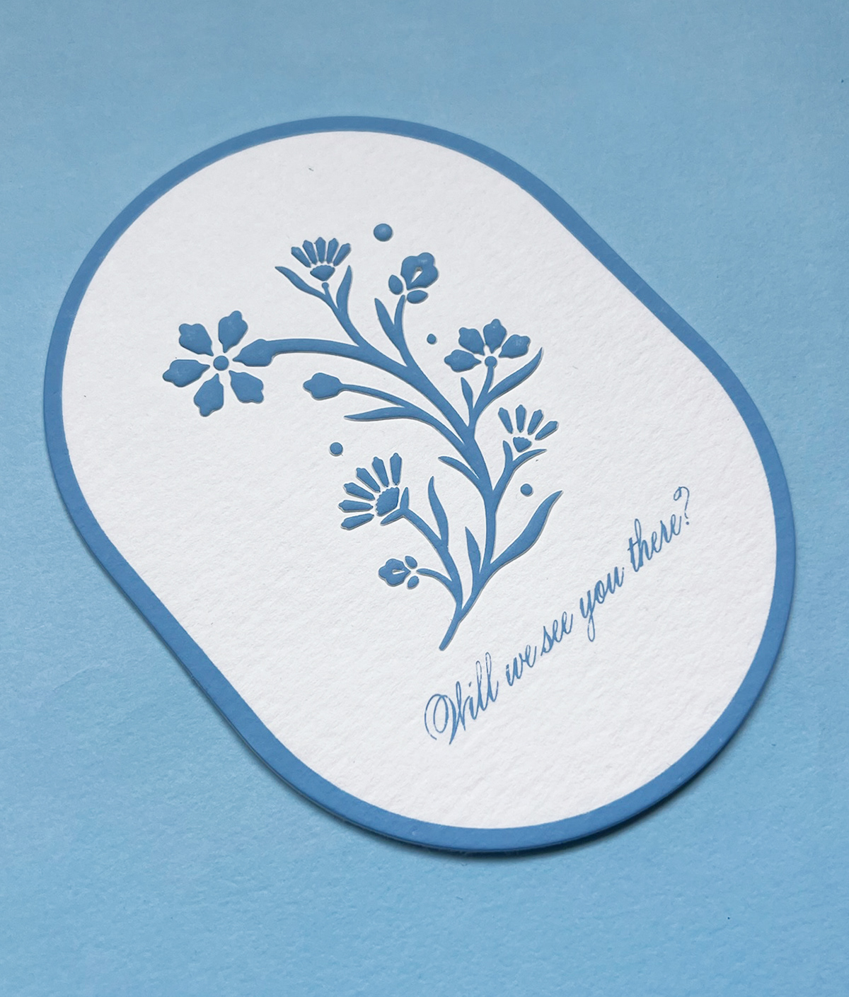 A heavy emboss on the flower for the RSVP card