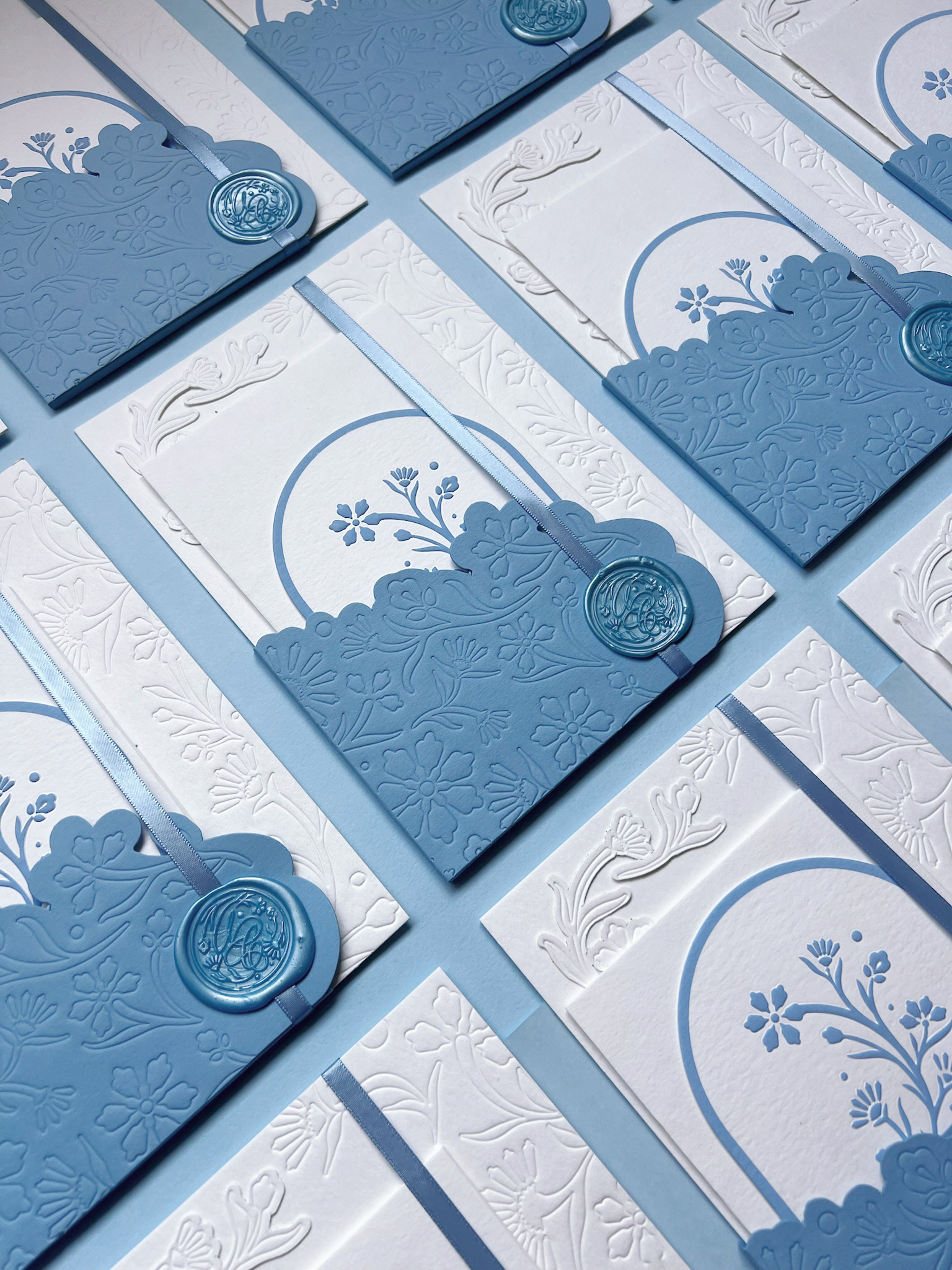 The cards were sealed in a die-cut booklet with debossed art and hand sealed with a custom wax seal