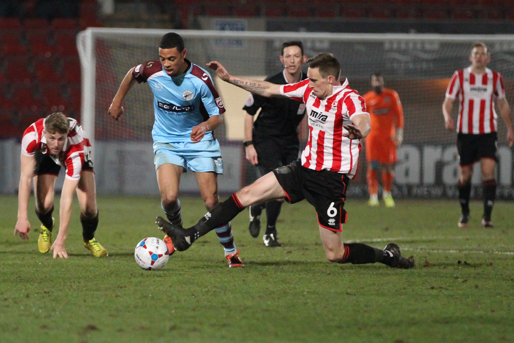 A clean tackle by Cheltenham Town player Dan Parslow stops Grimsby Town attack