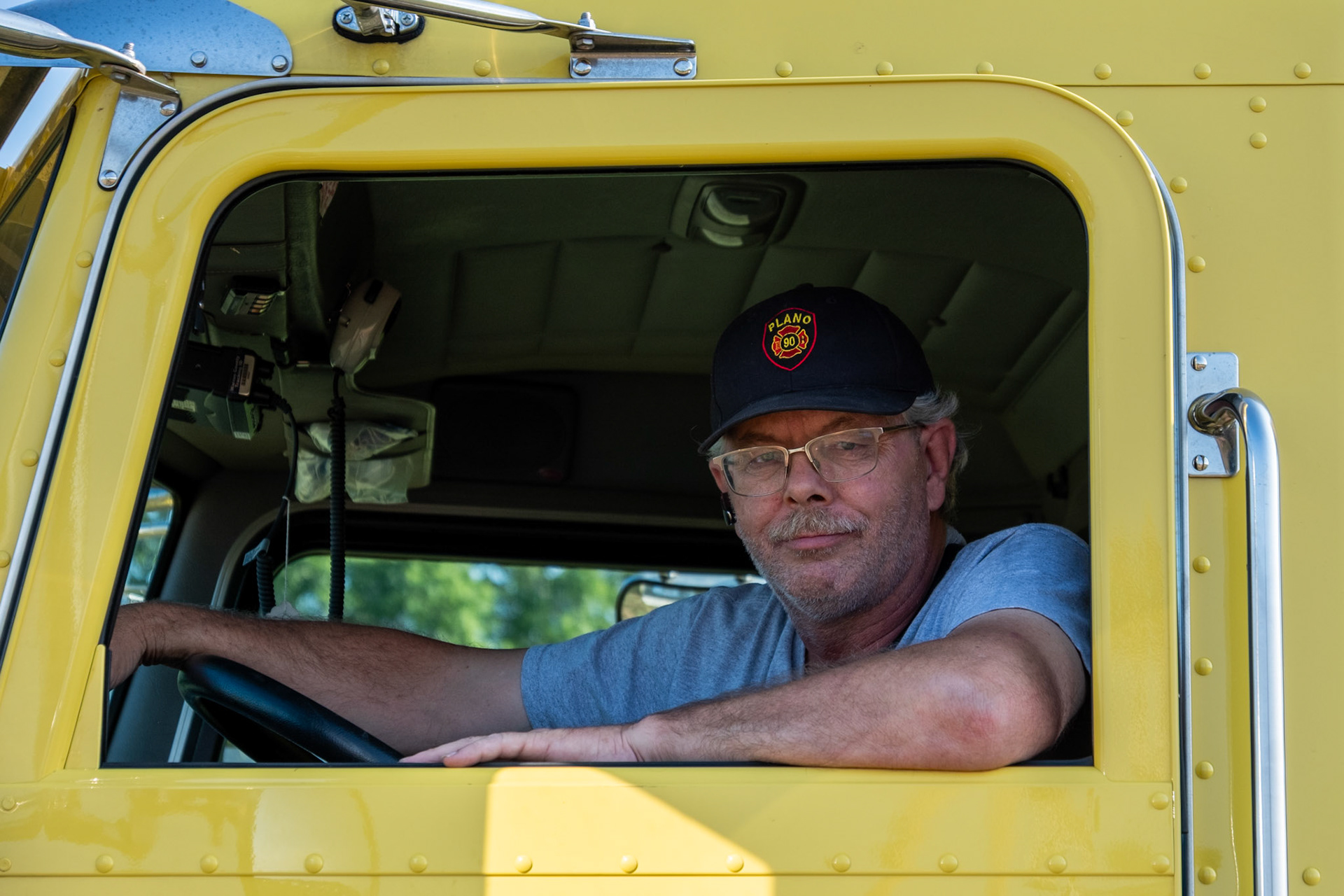 Kent Charlton, 54, sits in Fire Tanker 93 during the annual Bowling Green Mud Run, taking place at Phil Moore Park on Aug, 23. Charlton had been a volunteer at the Plano Fire Department for 33 years.