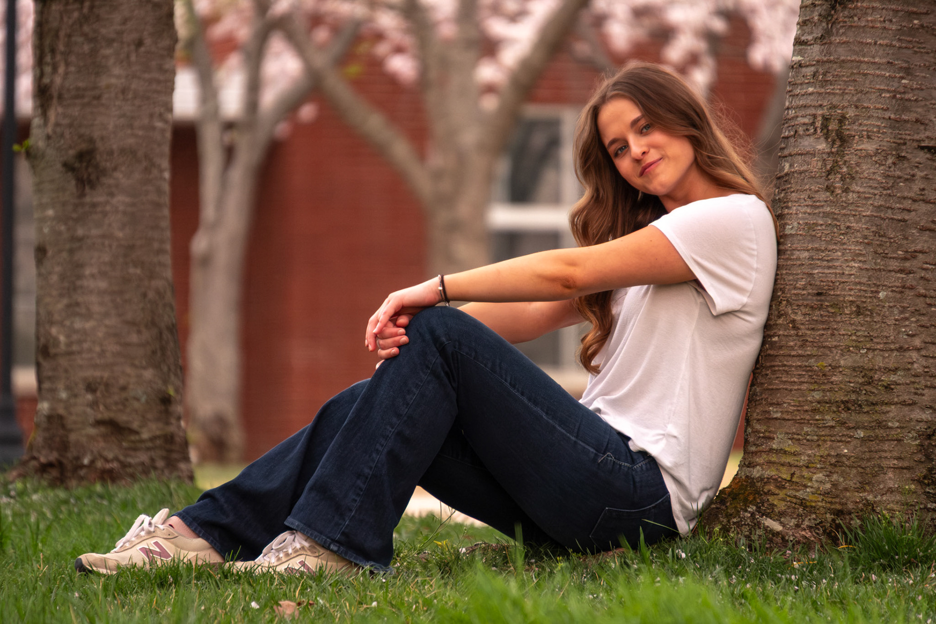Olena Makhnovets, 18, poses in various locations across Western Kentucky University's campus on March 28, 2025. Following weeks of unpredictable weather, the campus was covered in white and pink as cherry blossom trees began to bloom.
