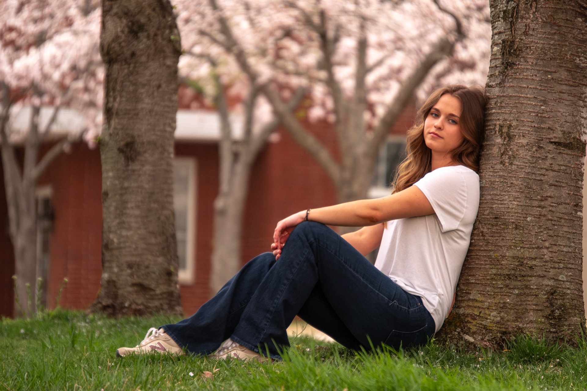 Olena Makhnovets, 18, poses in various locations across Western Kentucky University's campus on March 28, 2025. Following weeks of unpredictable weather, the campus was covered in white and pink as cherry blossom trees began to bloom.