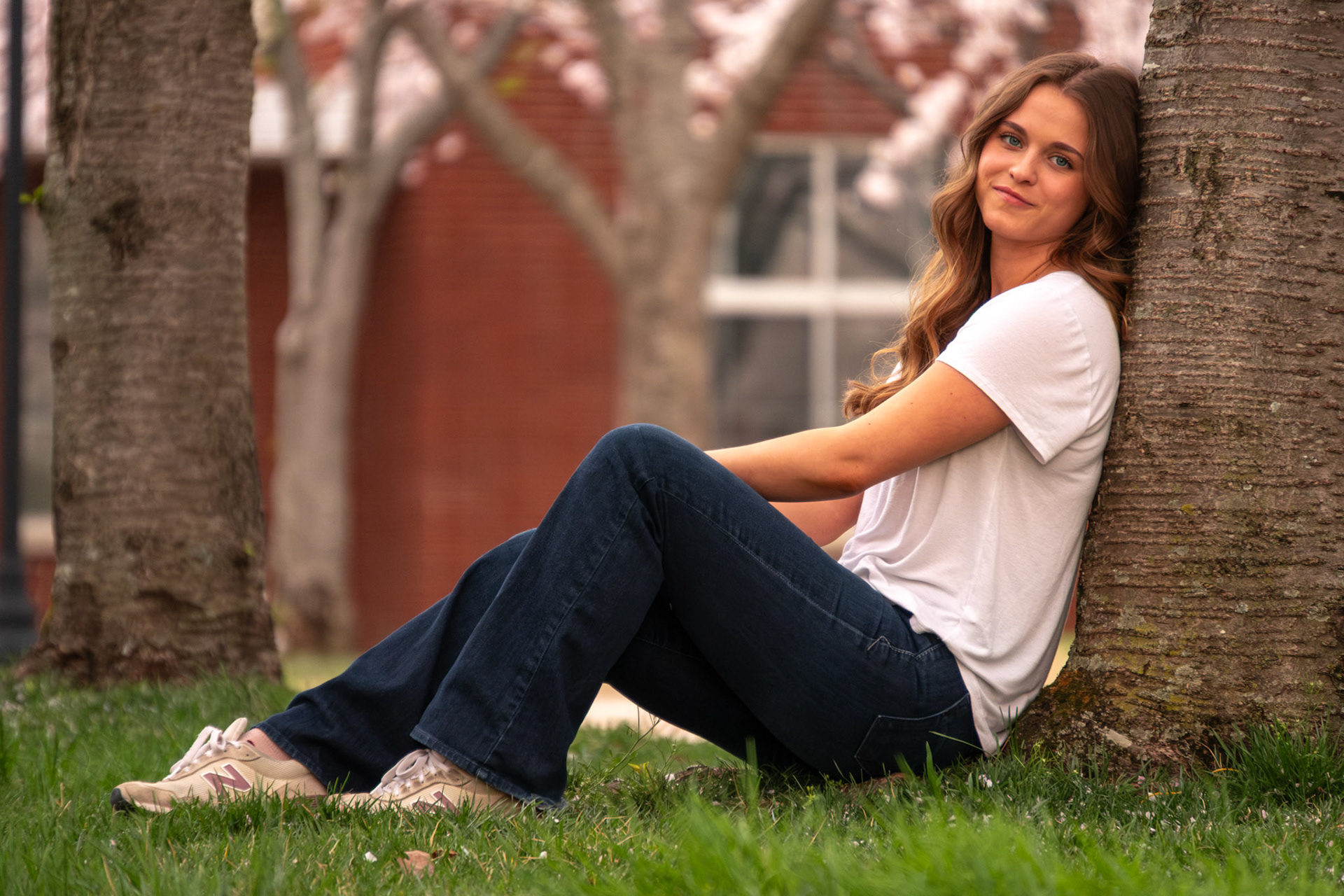 Olena Makhnovets, 18, poses in various locations across Western Kentucky University's campus on March 28, 2025. Following weeks of unpredictable weather, the campus was covered in white and pink as cherry blossom trees began to bloom.