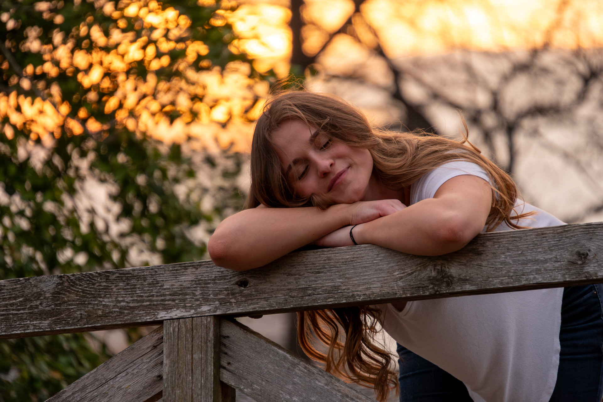 Olena Makhnovets, 18, poses in various locations across Western Kentucky University's campus on March 28, 2025. Following weeks of unpredictable weather, the campus was covered in white and pink as cherry blossom trees began to bloom.
