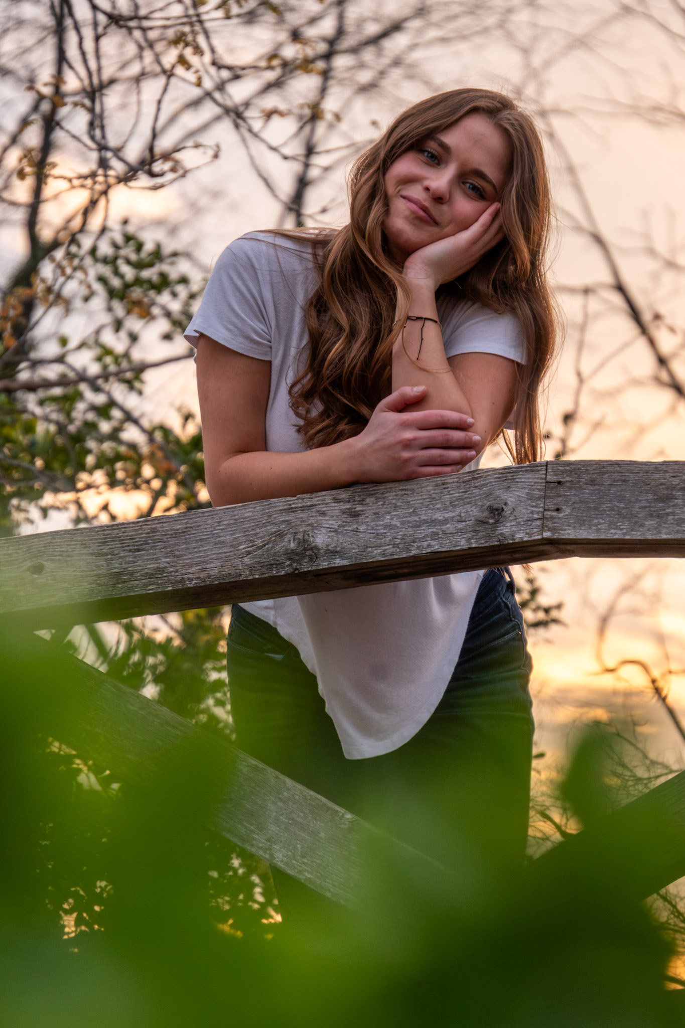 Olena Makhnovets, 18, poses in various locations across Western Kentucky University's campus on March 28, 2025. Following weeks of unpredictable weather, the campus was covered in white and pink as cherry blossom trees began to bloom.