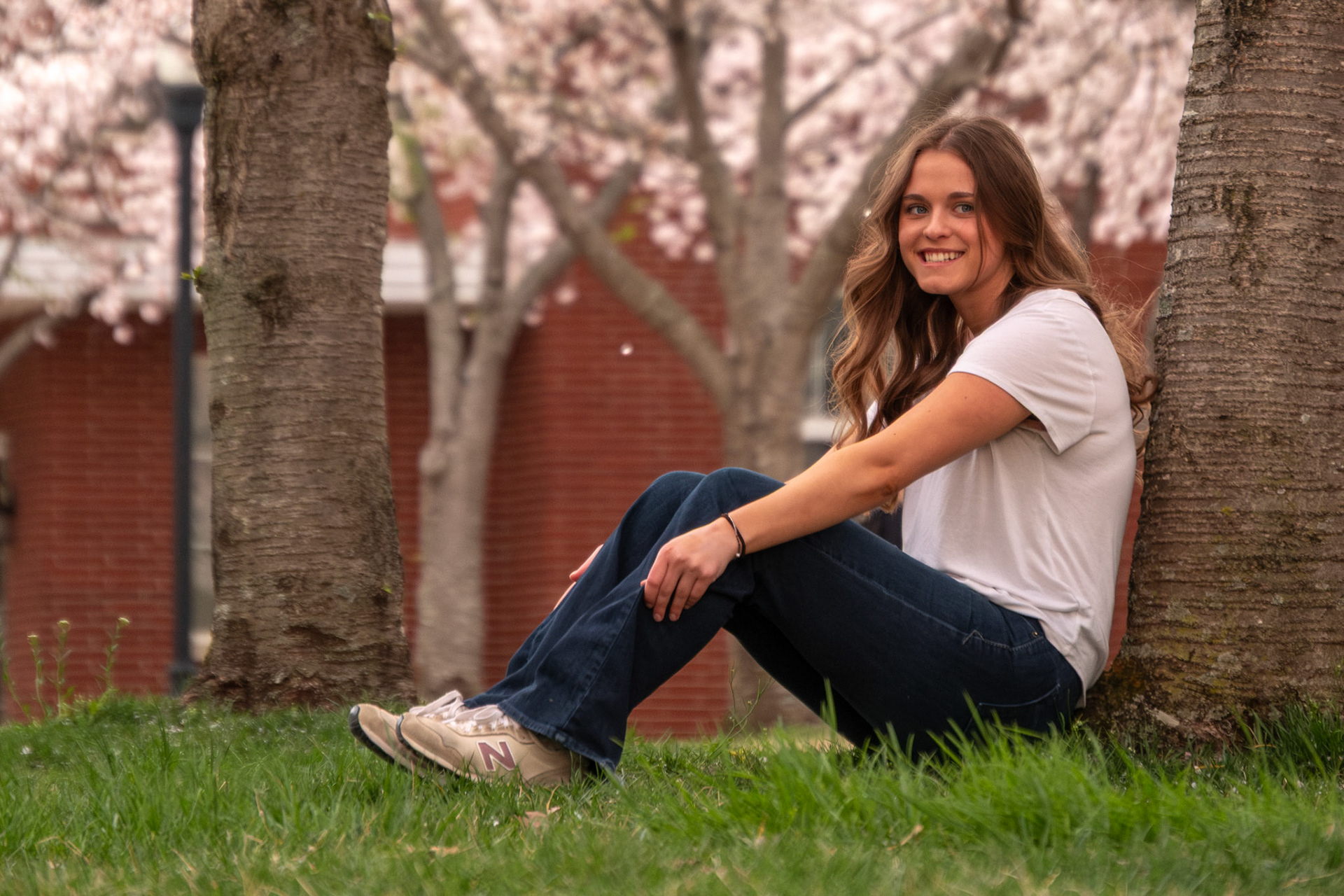 Olena Makhnovets, 18, poses in various locations across Western Kentucky University's campus on March 28, 2025. Following weeks of unpredictable weather, the campus was covered in white and pink as cherry blossom trees began to bloom.