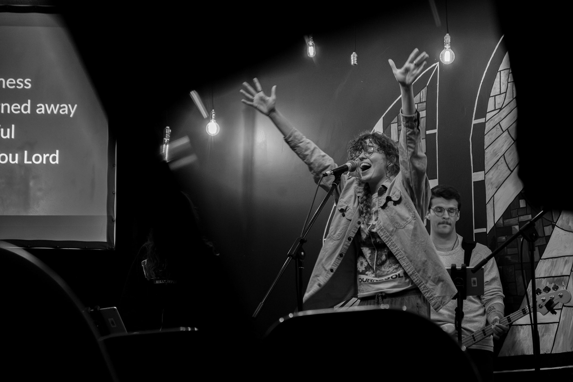 CSF Staff Member Olivia Cooney leads the congregation in worship songs on Aprill 22, during Tuesday worship night.