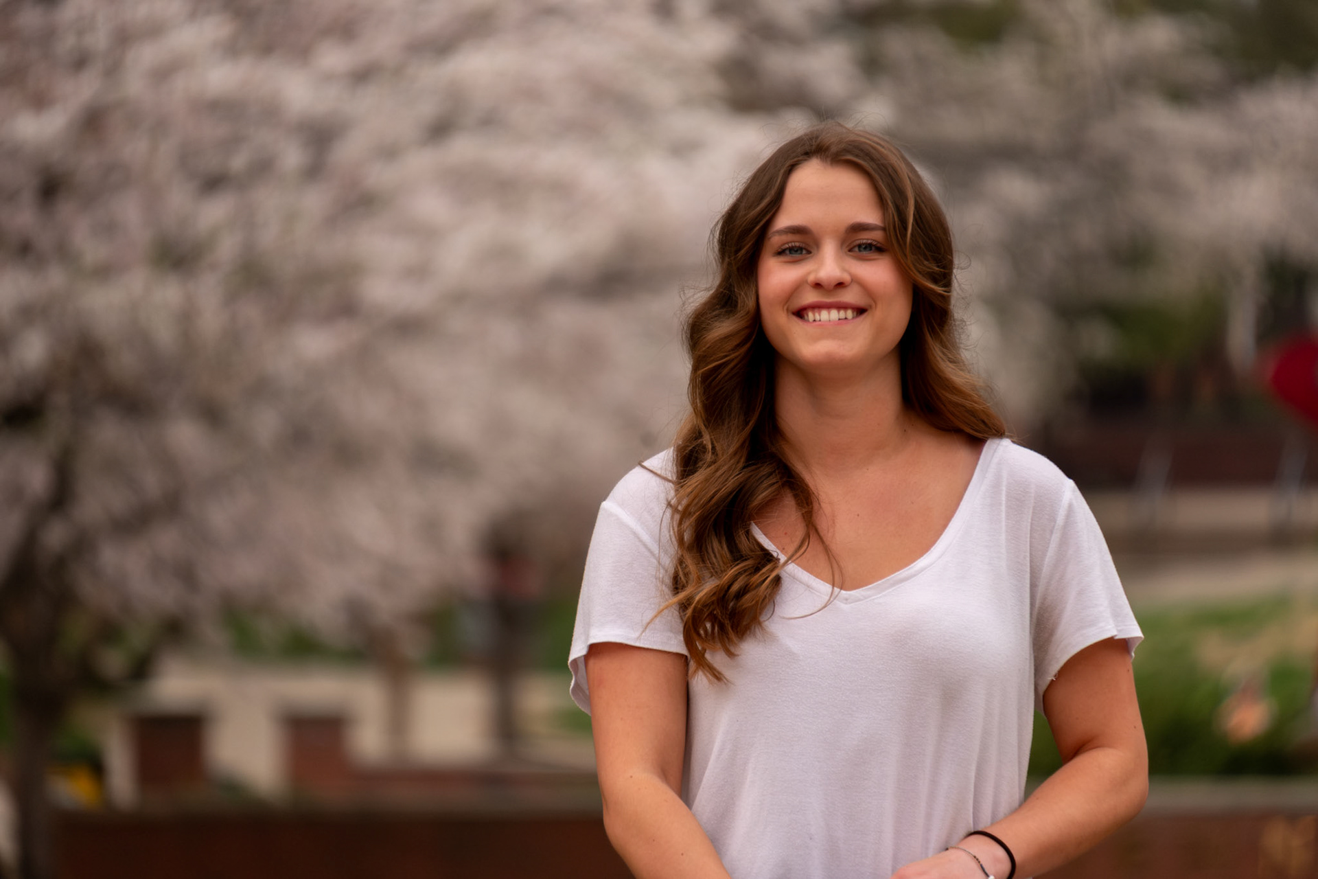 Olena Makhnovets, 18, poses in various locations across Western Kentucky University's campus on March 28, 2025. Following weeks of unpredictable weather, the campus was covered in white and pink as cherry blossom trees began to bloom.