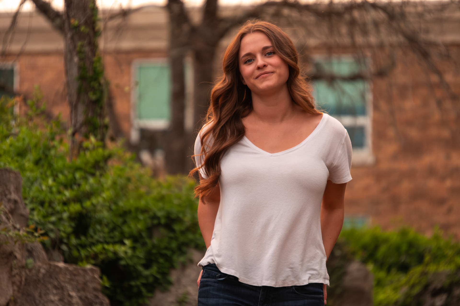 Olena Makhnovets, 18, poses in various locations across Western Kentucky University's campus on March 28, 2025. Following weeks of unpredictable weather, the campus was covered in white and pink as cherry blossom trees began to bloom.