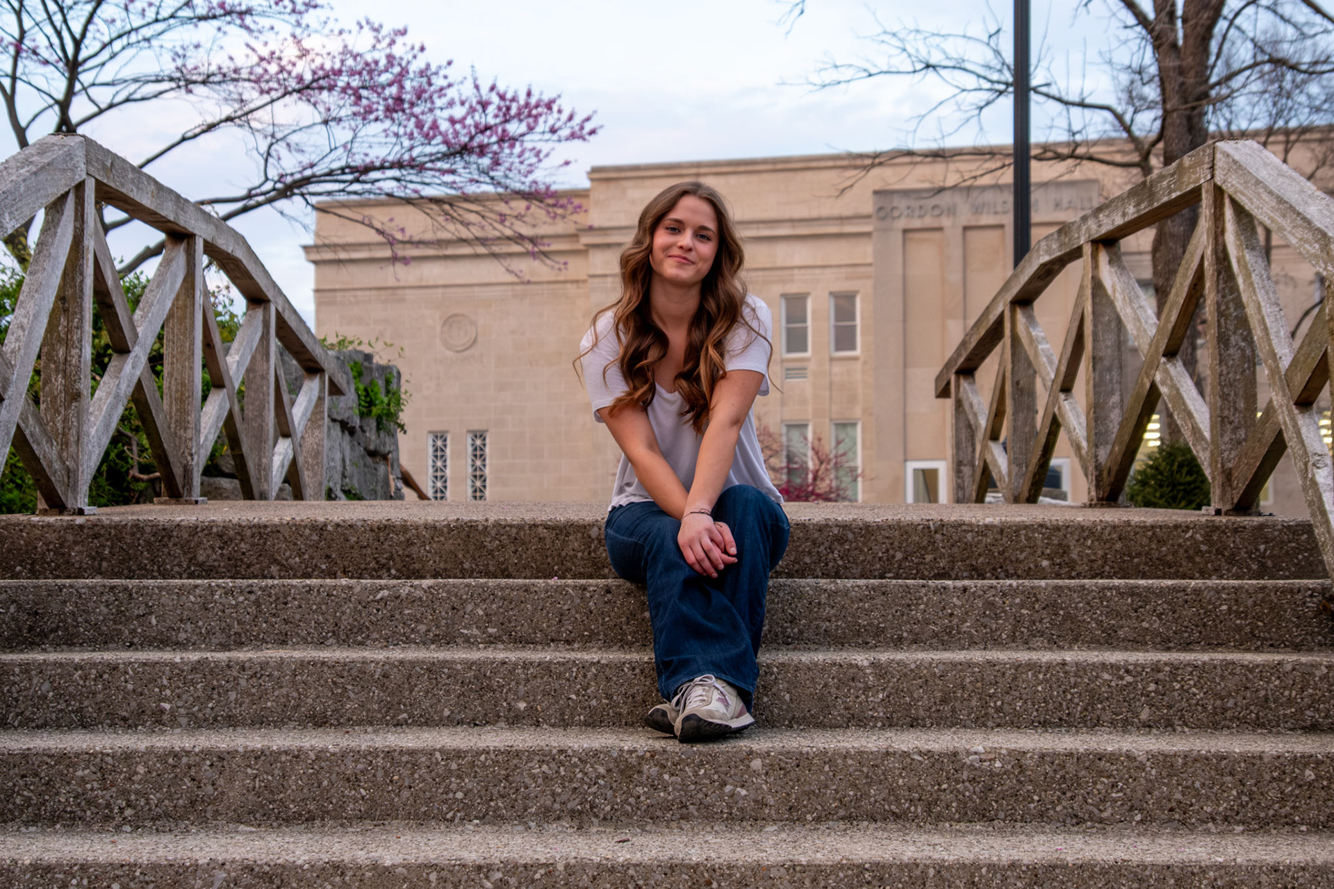Olena Makhnovets, 18, poses in various locations across Western Kentucky University's campus on March 28, 2025. Following weeks of unpredictable weather, the campus was covered in white and pink as cherry blossom trees began to bloom.