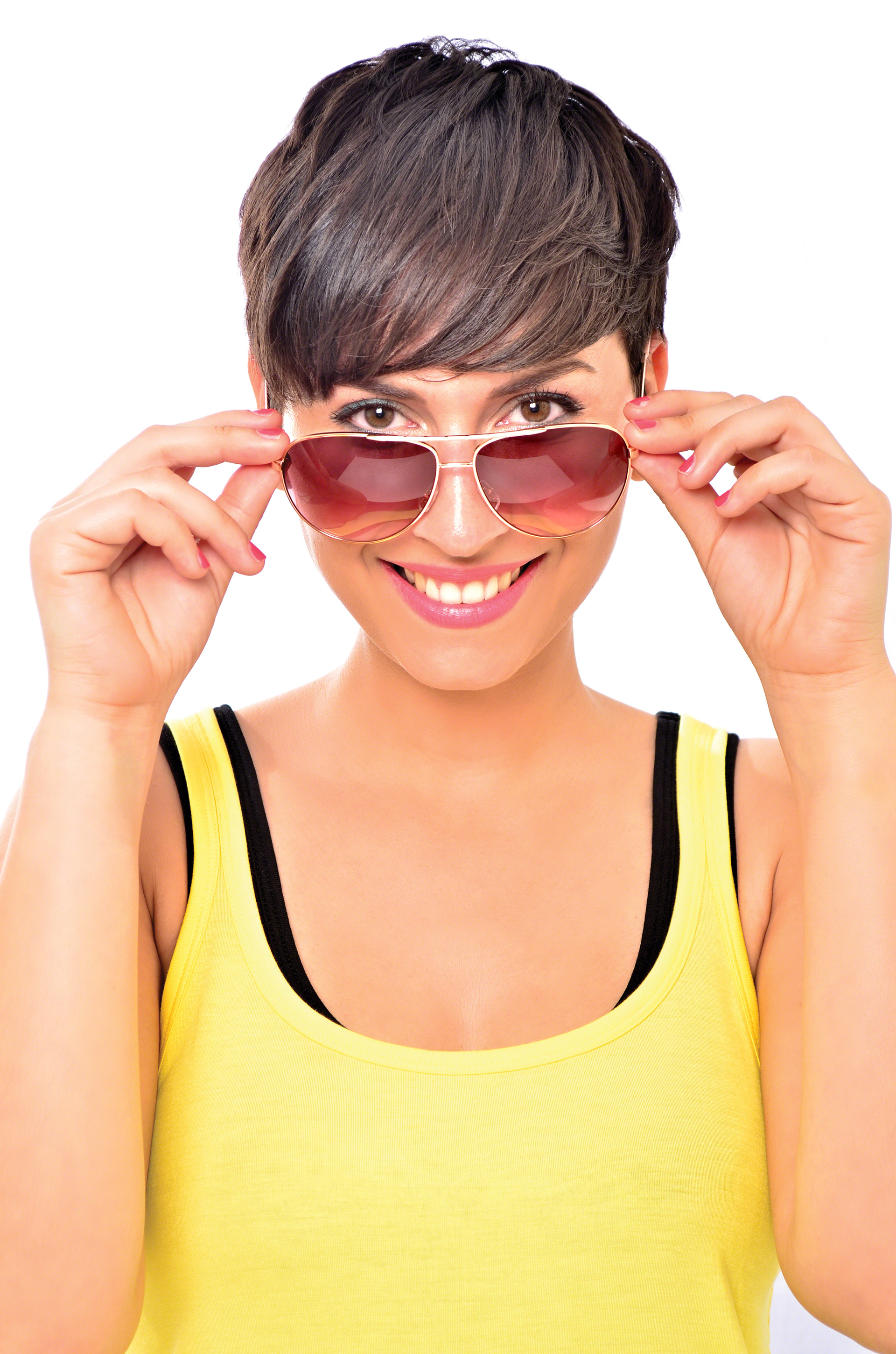 Studio image of Brunette Female model looking into the camera with sunglasses on studio lighting