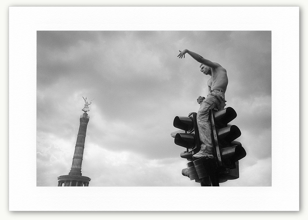 Steve Hanson Photography Man on top of a traffic light, Love Parade, Berlin, Germany.