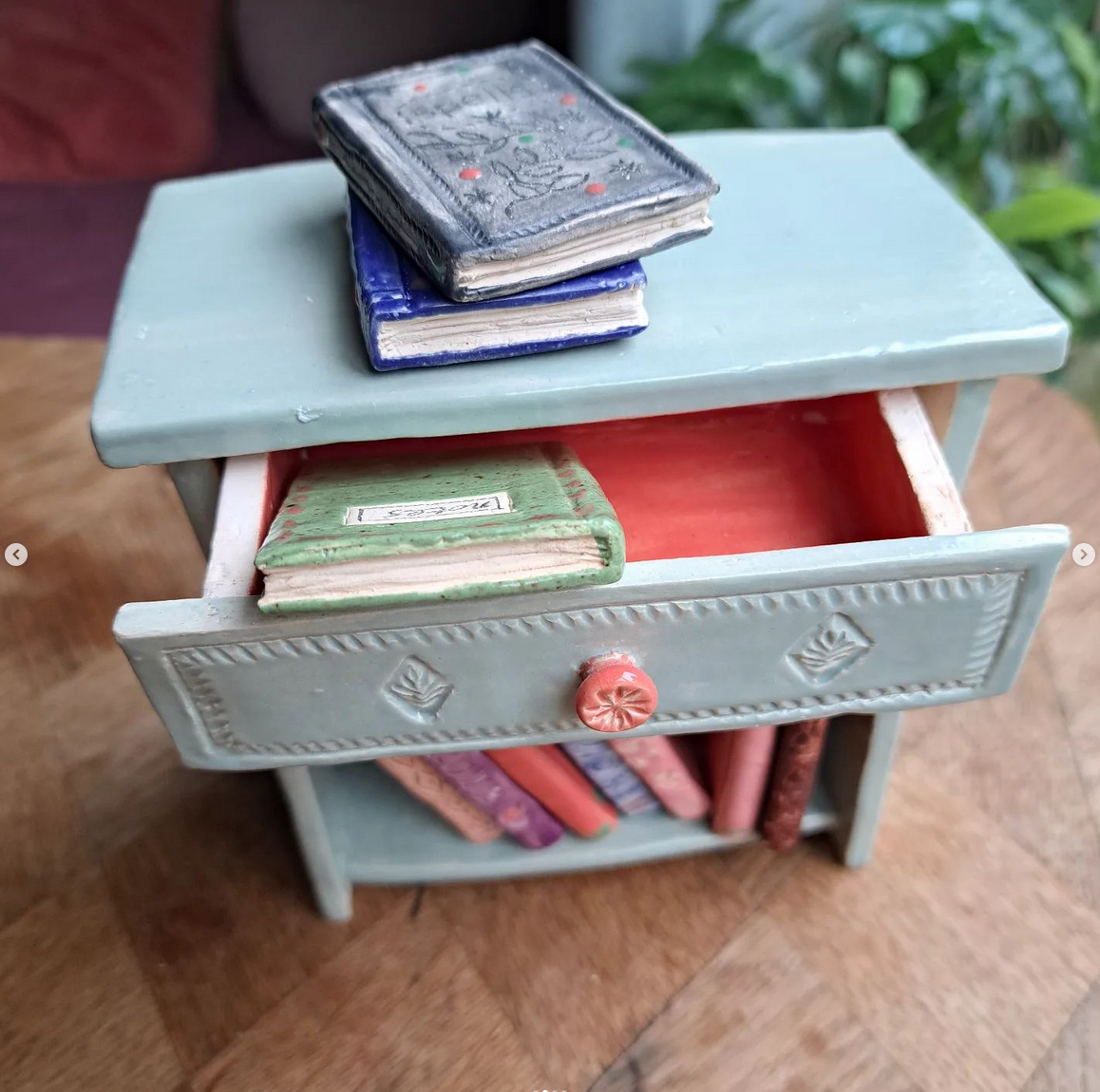 Open the little drawer to peek inside