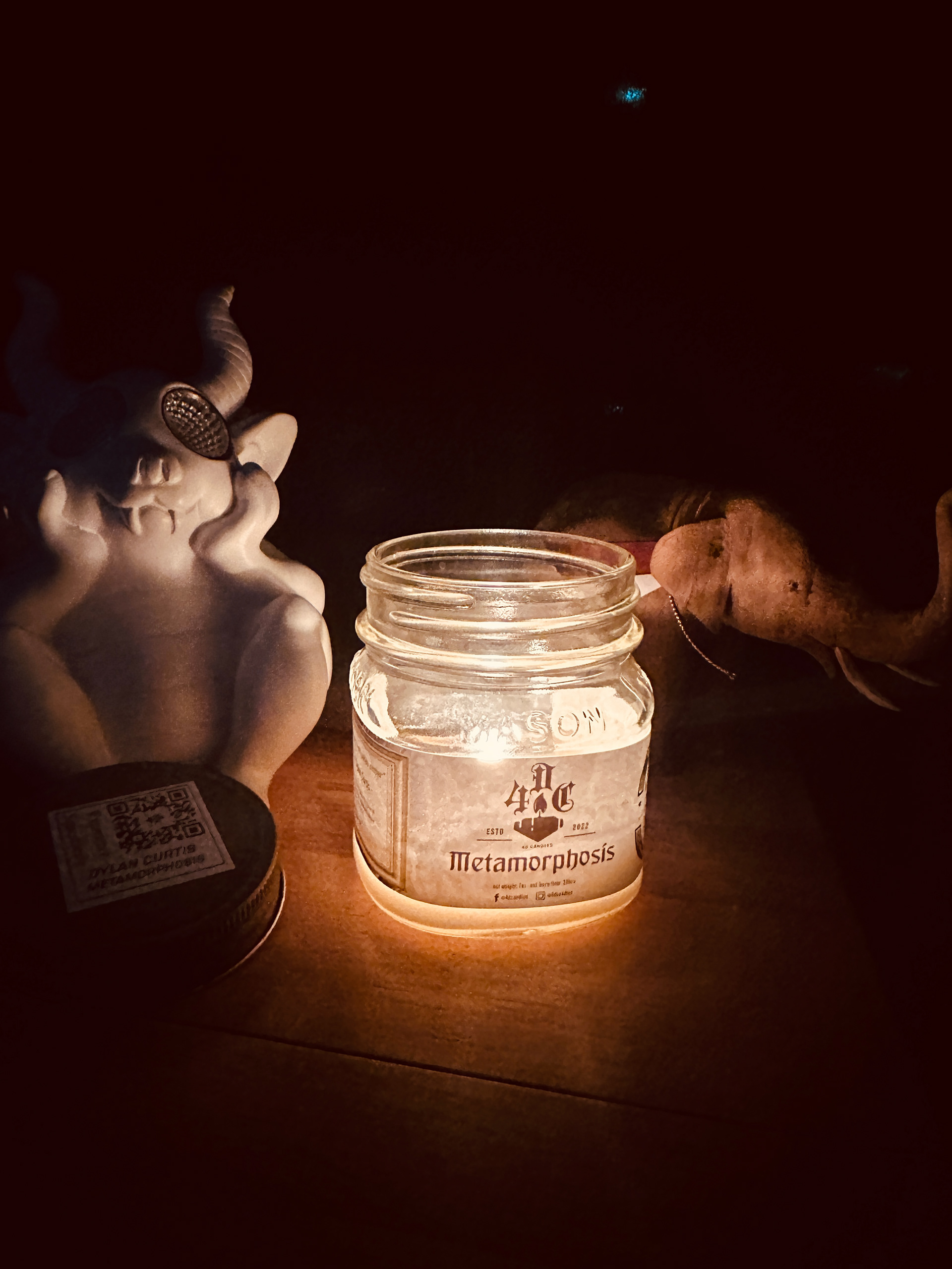 'Metamorphosis' candle, lit at night.