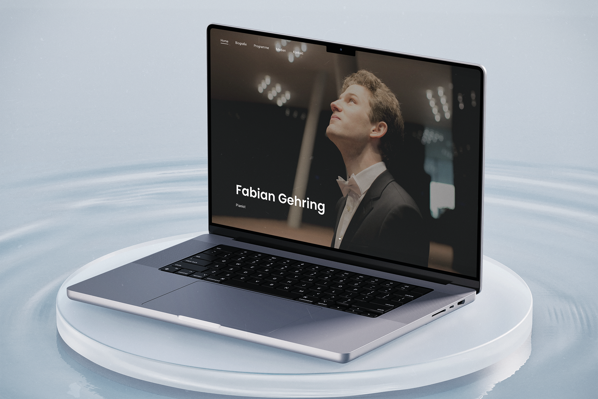 Homepage of fabiangehring.com displayed on a MacBook, floating on a light reflective surface. Website features a minimalist portrait and serif type.
