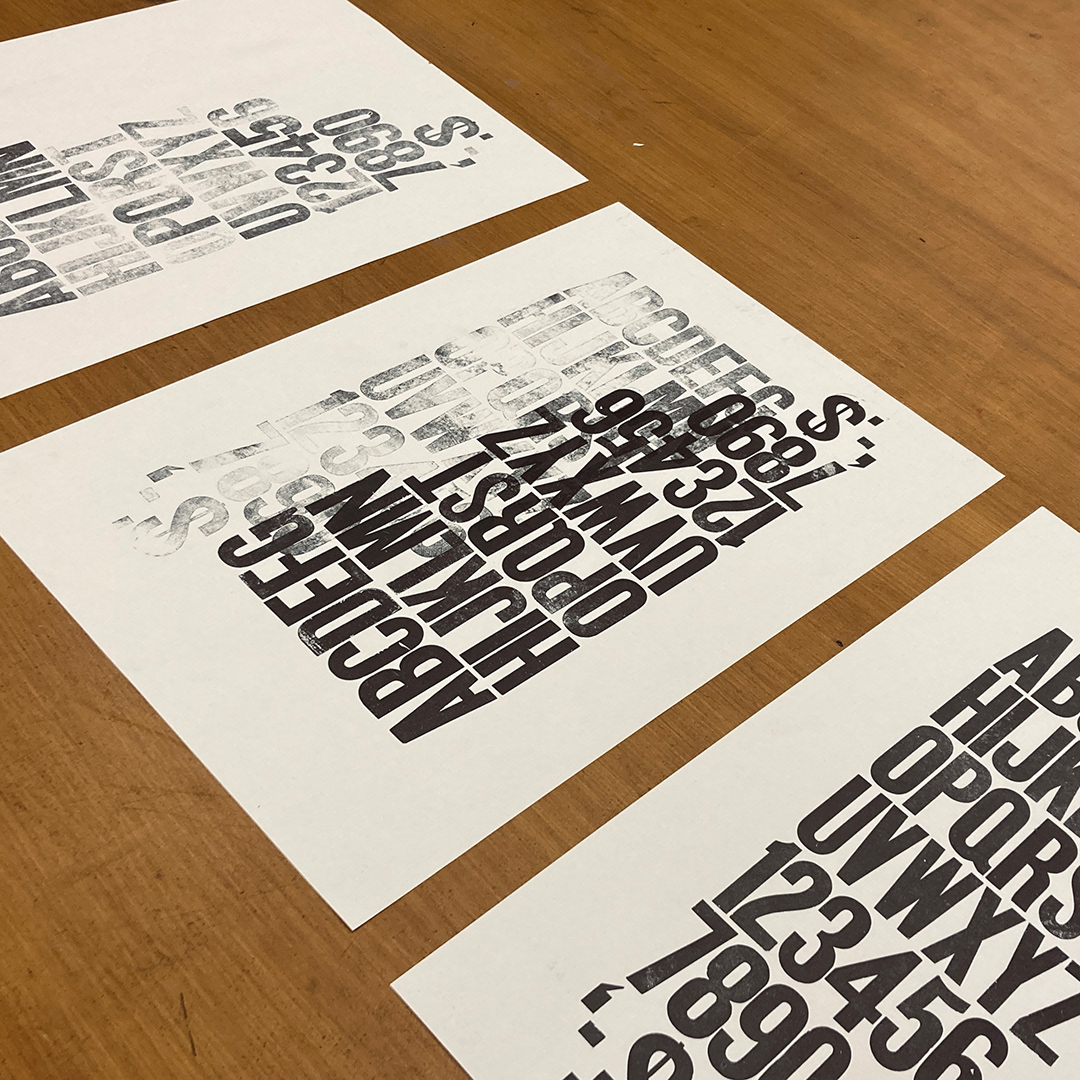 Three large posters on white paper, each with slight variations of the same image. The alphabetical characters, numerals, and symbols of the original 144pt wooden fonts printed in fading black ink in rows with no leading or letter spacing, flush left with two inch side margins and inconsistent top and bottom margins.