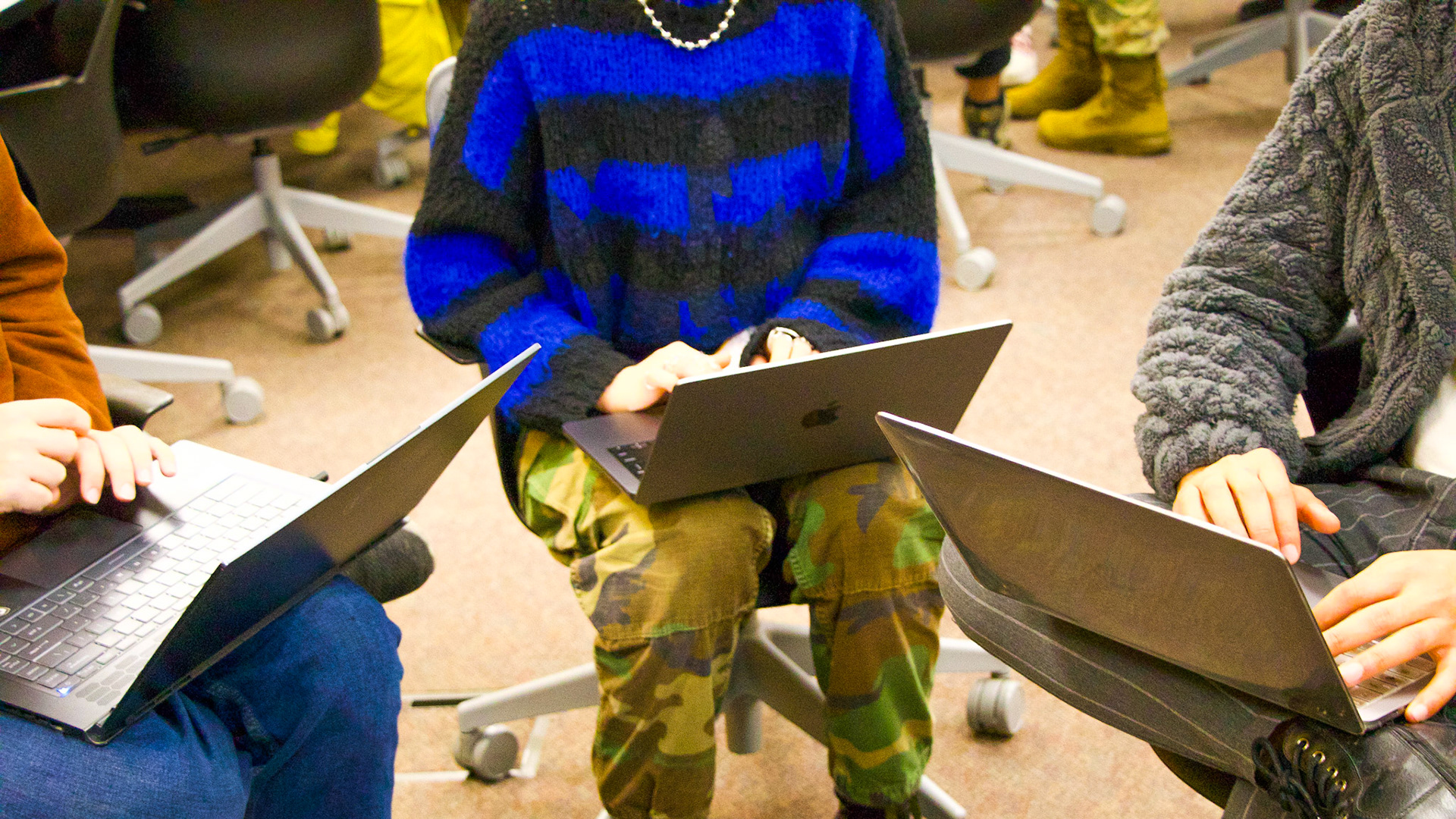 Blacksburg, Virginia, Feb. 19, 2025 --- AI in Action: Three students quickly complete their in-class assignment that explores generative AI concepts.