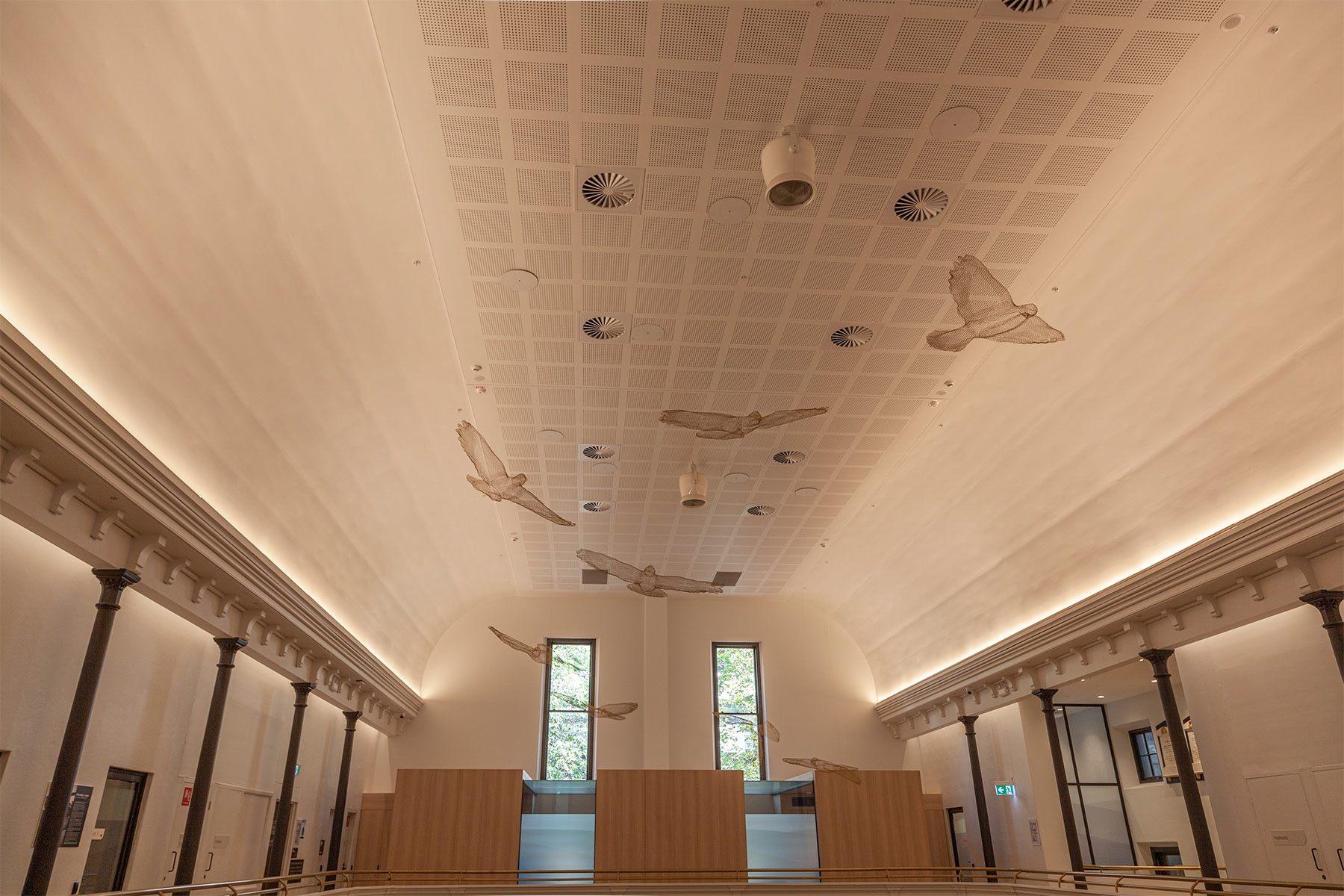metal mesh birds suspended from the ceiling