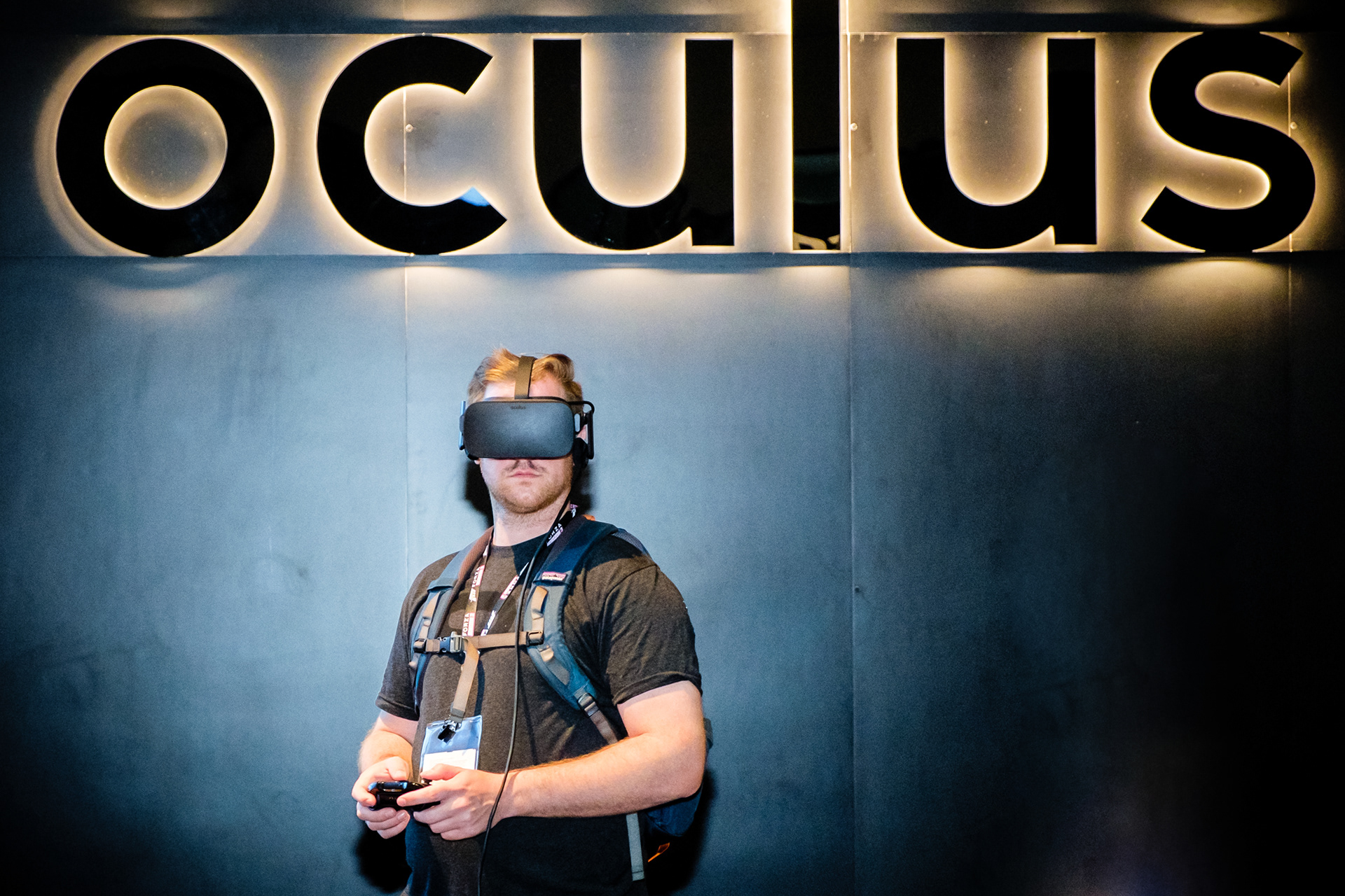 Attendee trying an Oculus virtual reality headset and controller at E3 Expo in Los Angeles.