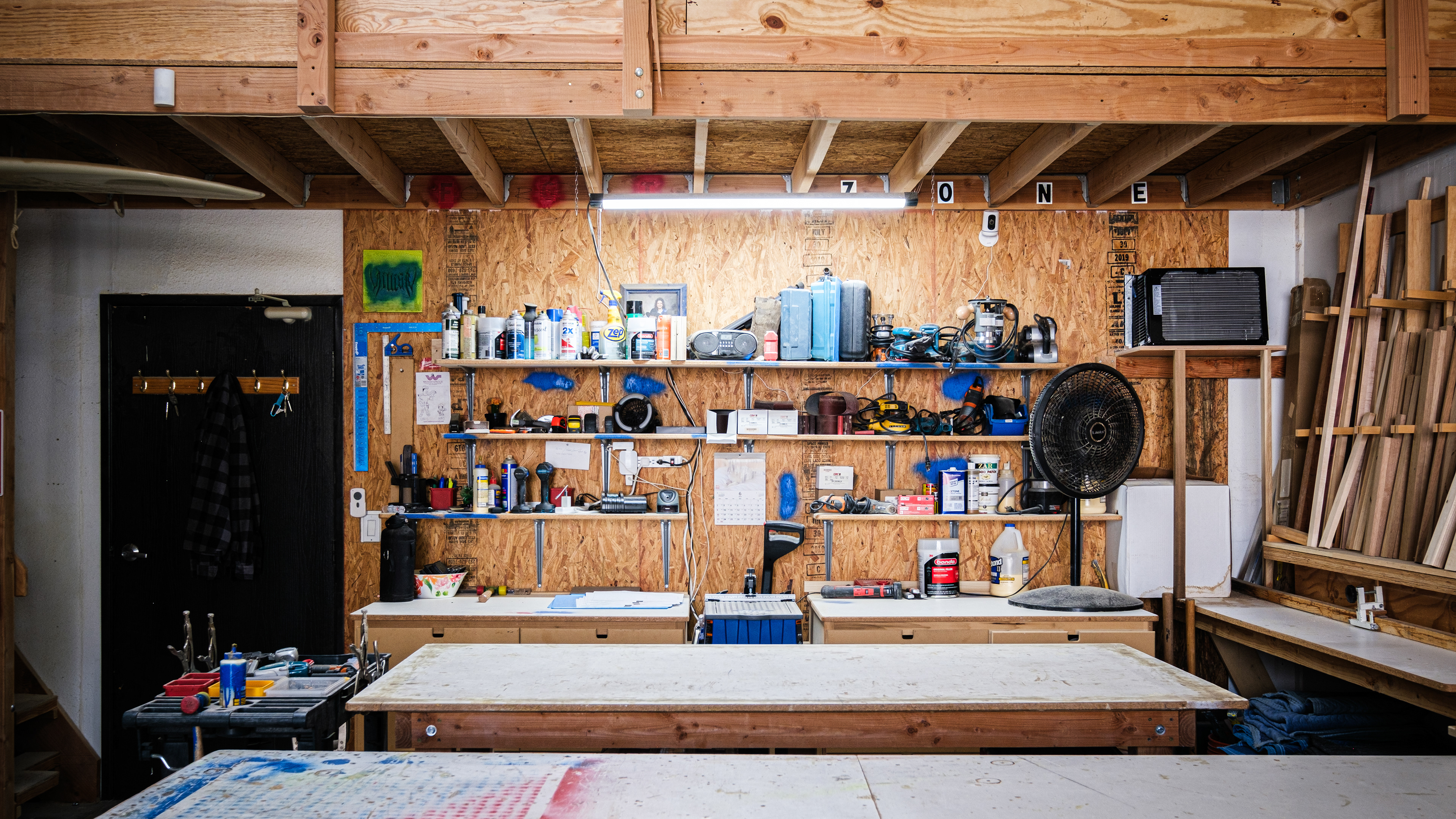 Woodworking shop with a workbench, hand tools and exposed timber beams